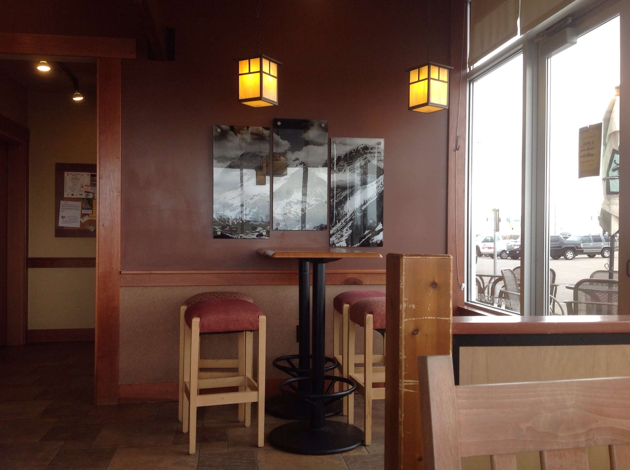 Interior of a coffee shop with bar stools and tables HD Wallpaper