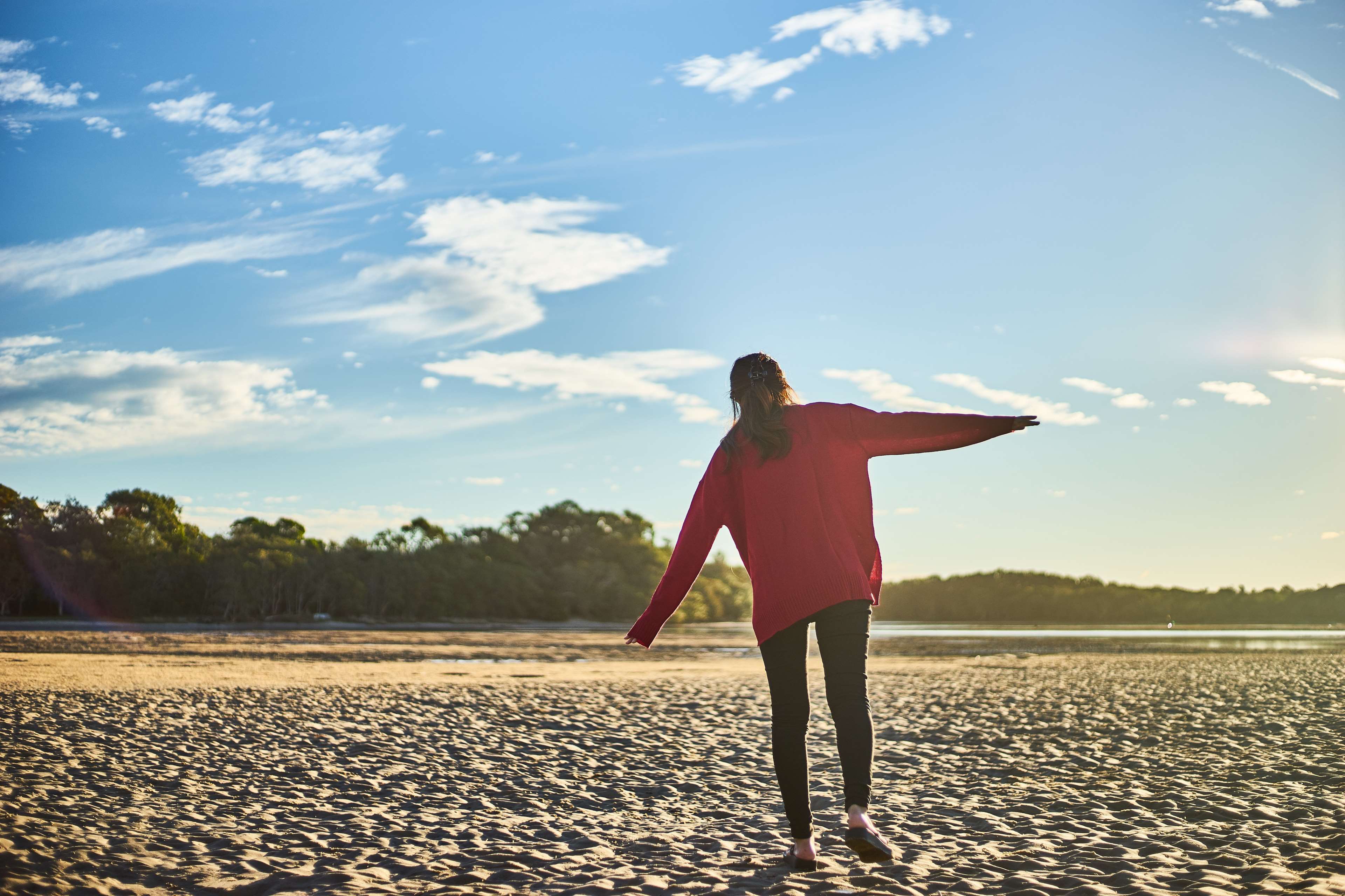 Woman in red sweater on a sandy beach HD Wallpaper