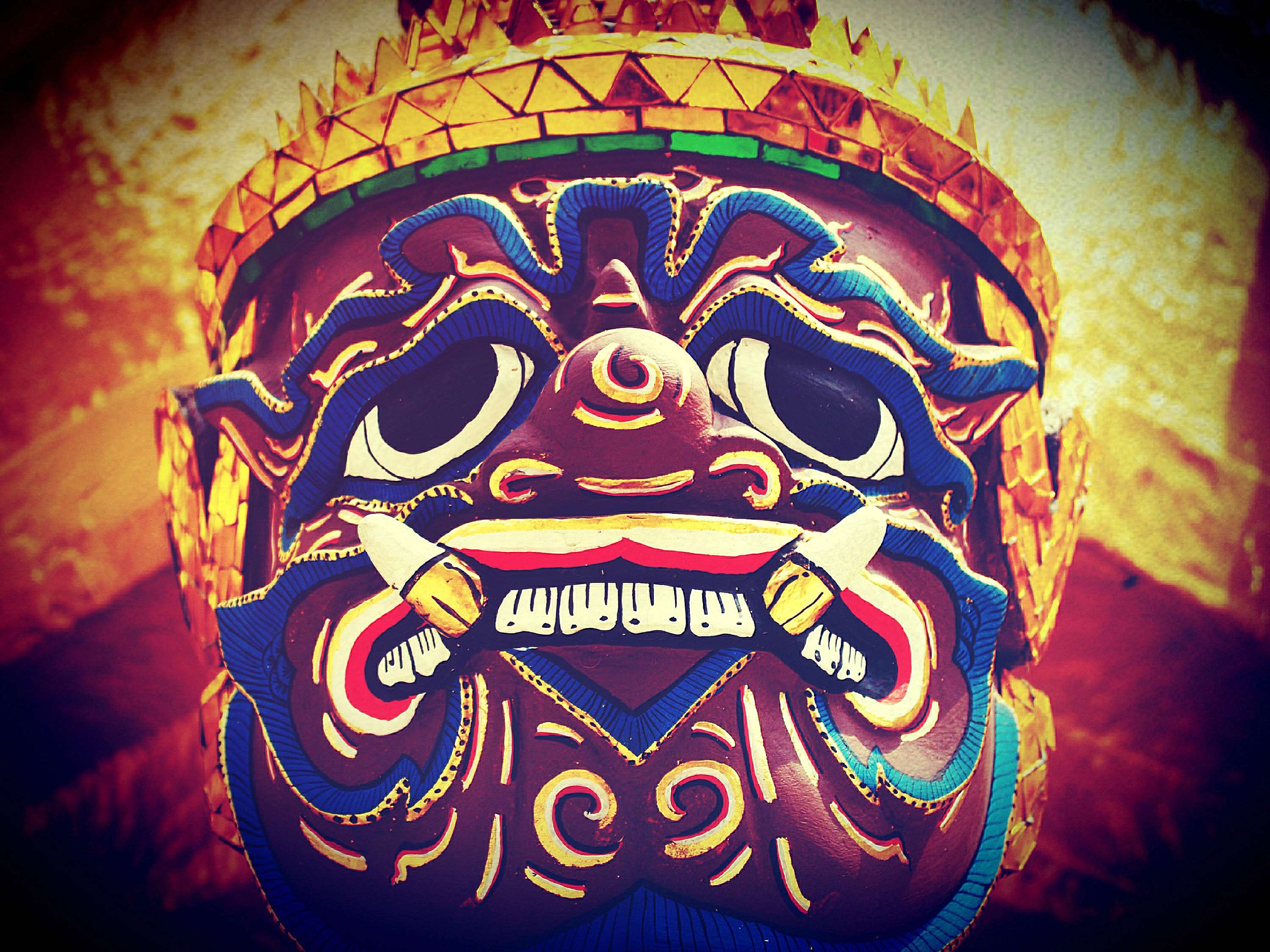 Close-up of a colorful Thai demon mask with golden headdress HD Wallpaper