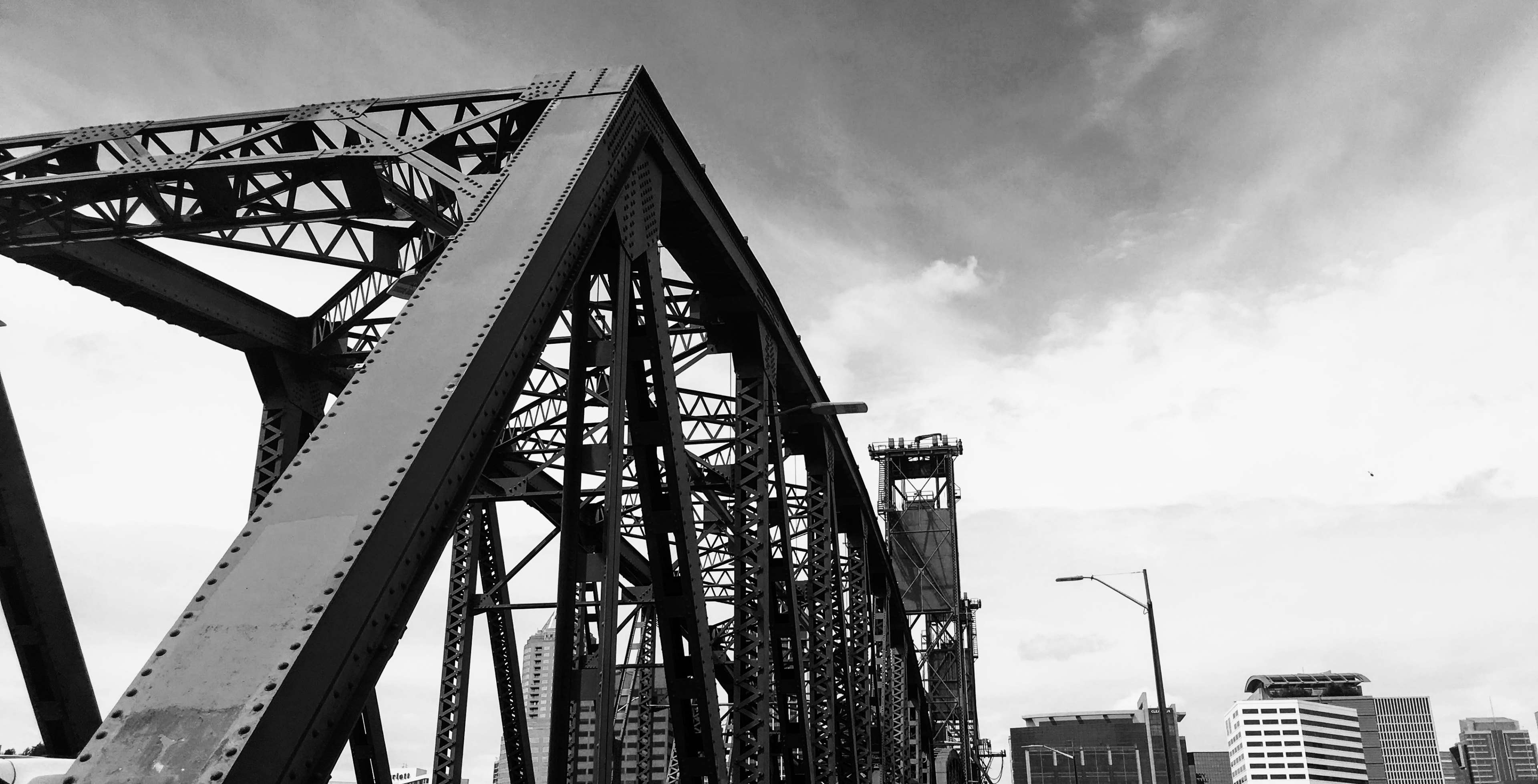 Black and white image of a steel bridge structure HD Wallpaper