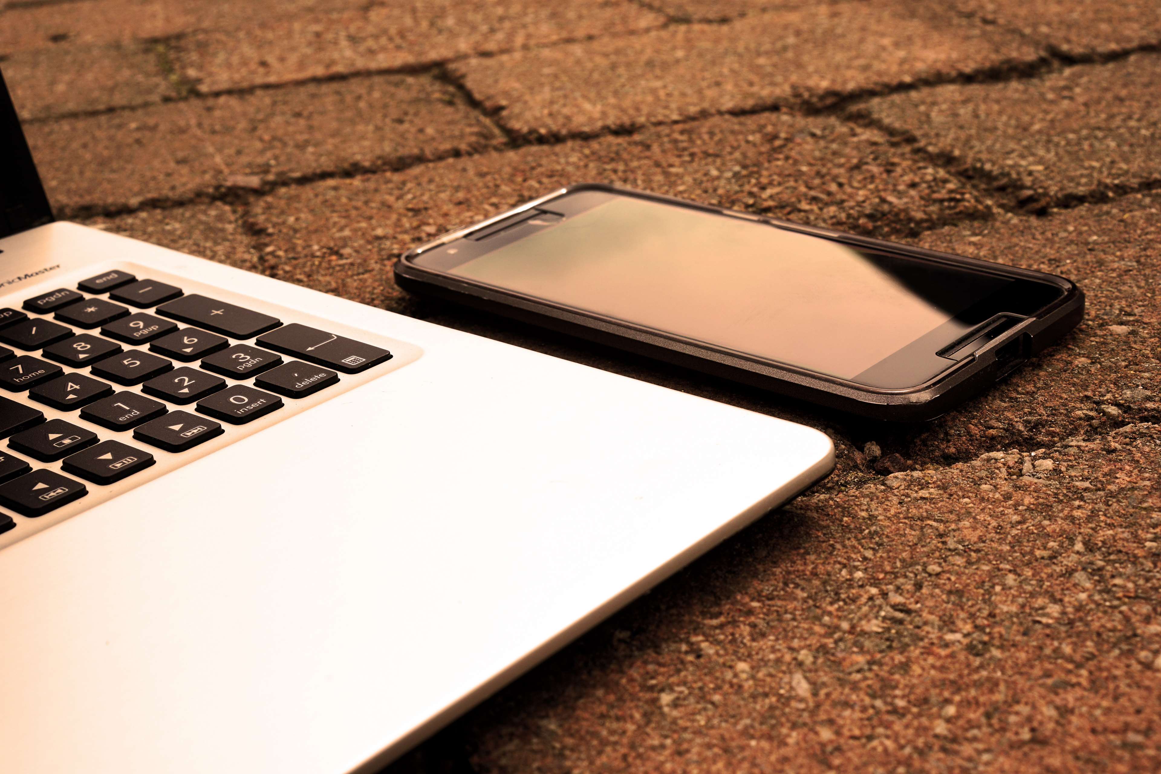 Laptop and smartphone on brick surface HD Wallpaper