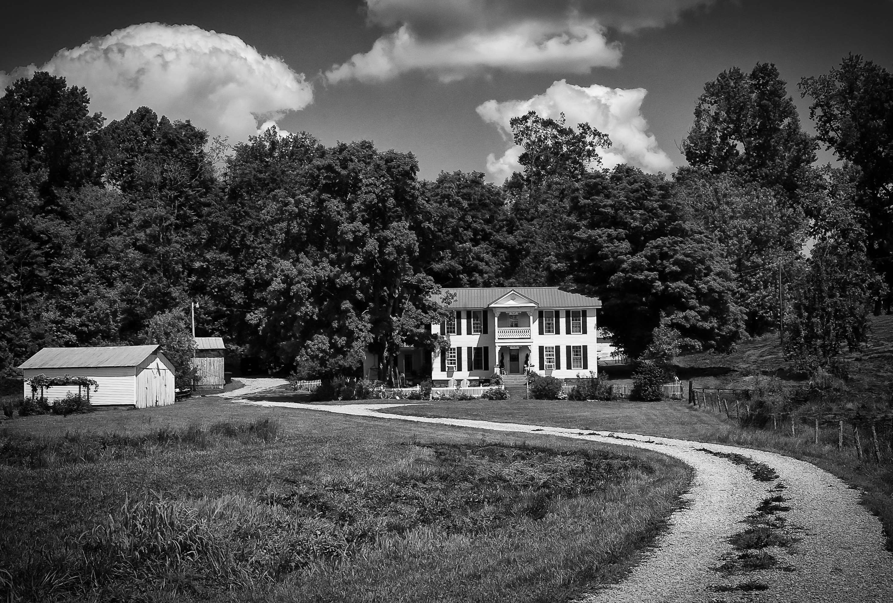 Black and white landscape of a rural manor with a gravel road HD Wallpaper