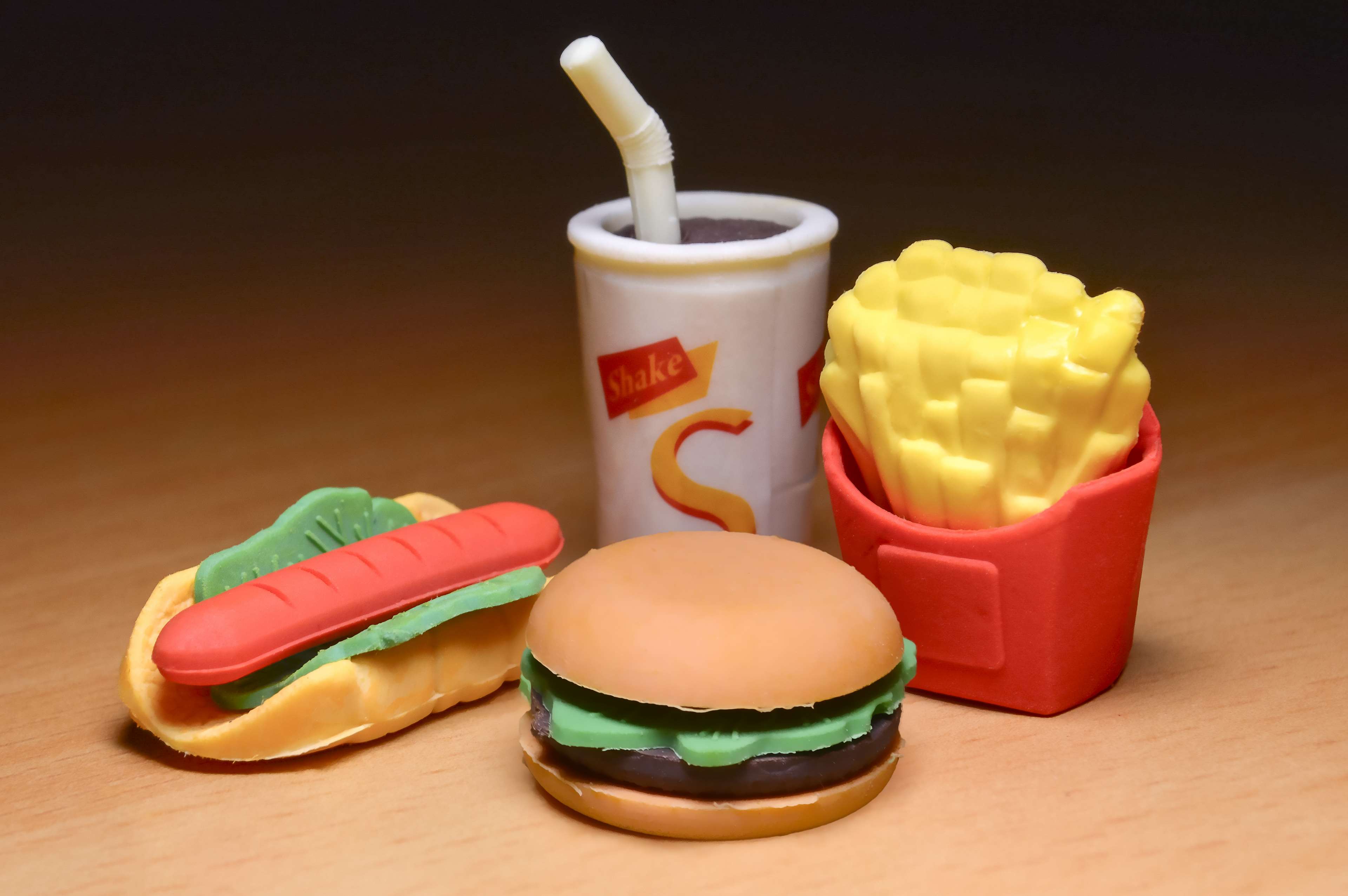 Plastic fast food toys: hamburger, hot dog, fries, and soda HD Wallpaper