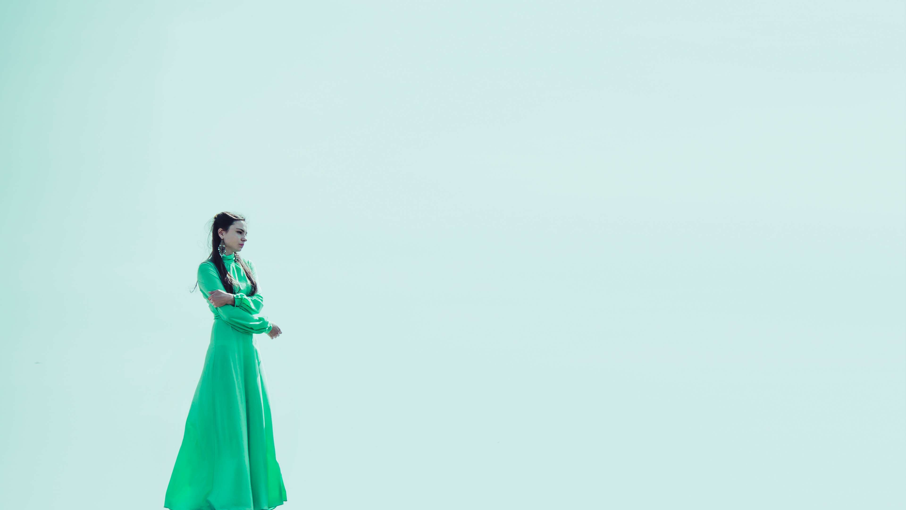 Woman in green dress on a light blue background HD Wallpaper