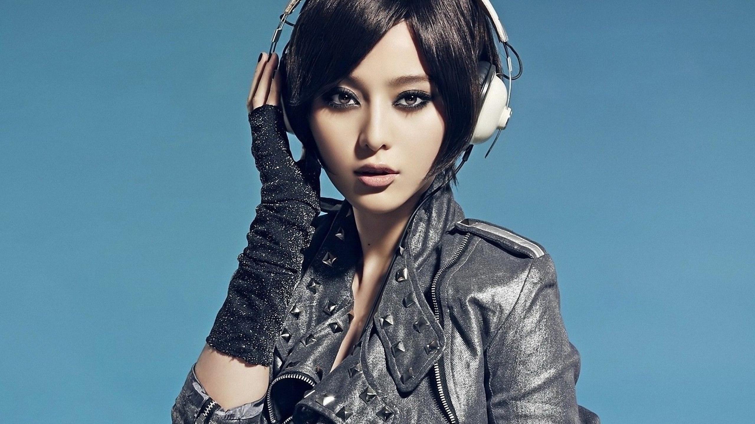 Asian girl with headphones and studded jacket HD Wallpaper