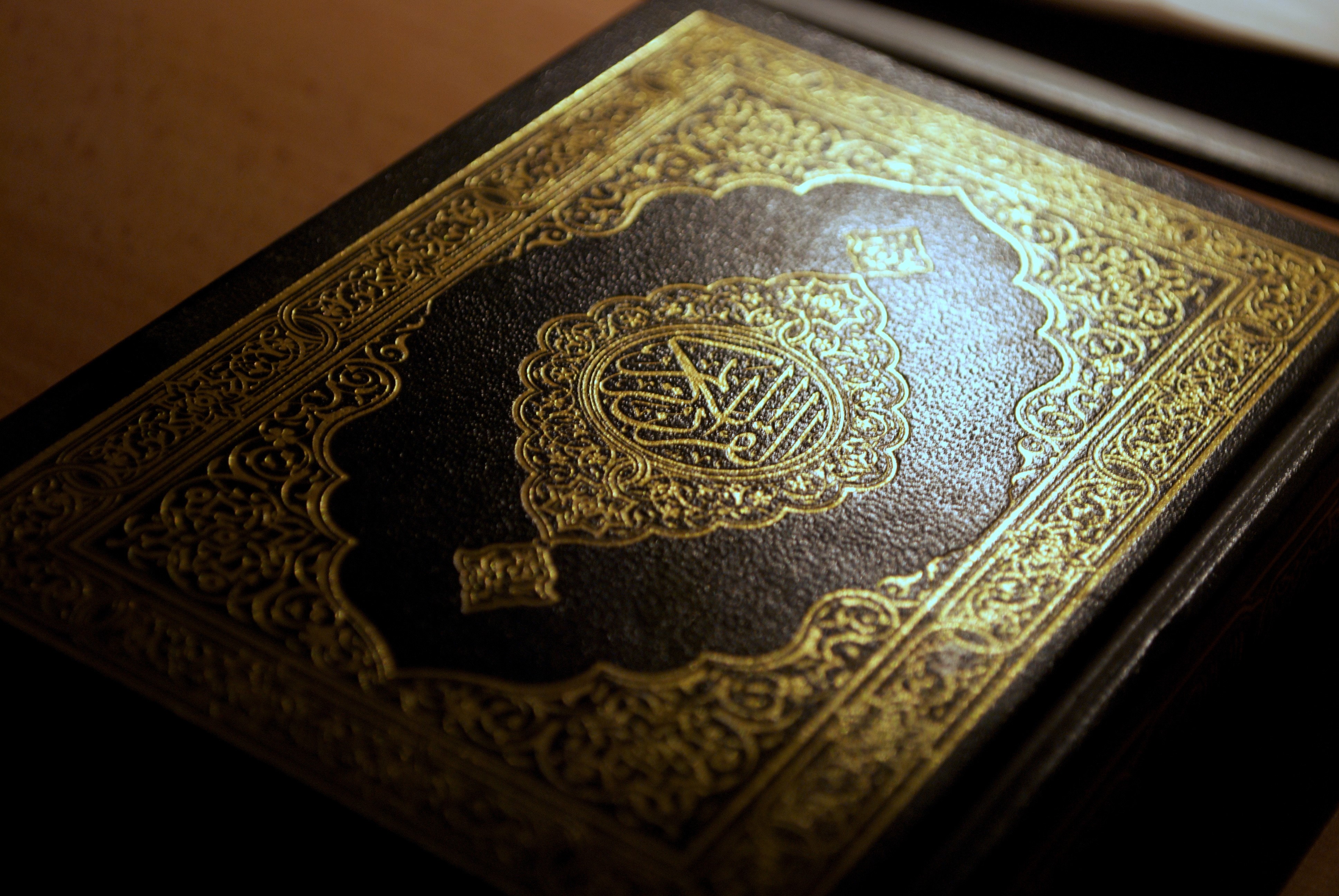 Intricately Designed Quran Cover with Golden Calligraphy HD Wallpaper