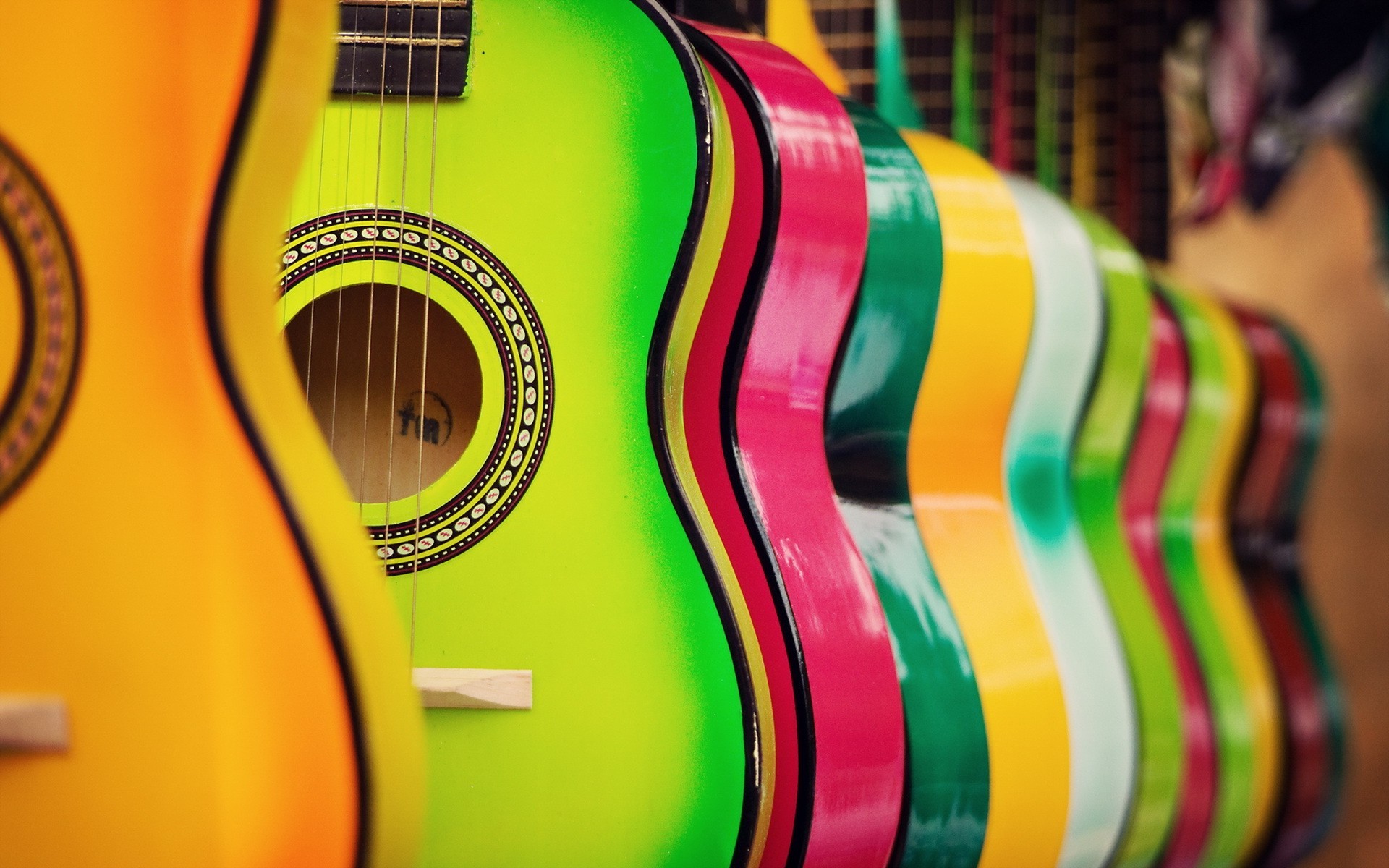 Row of colorful acoustic guitars HD Wallpaper