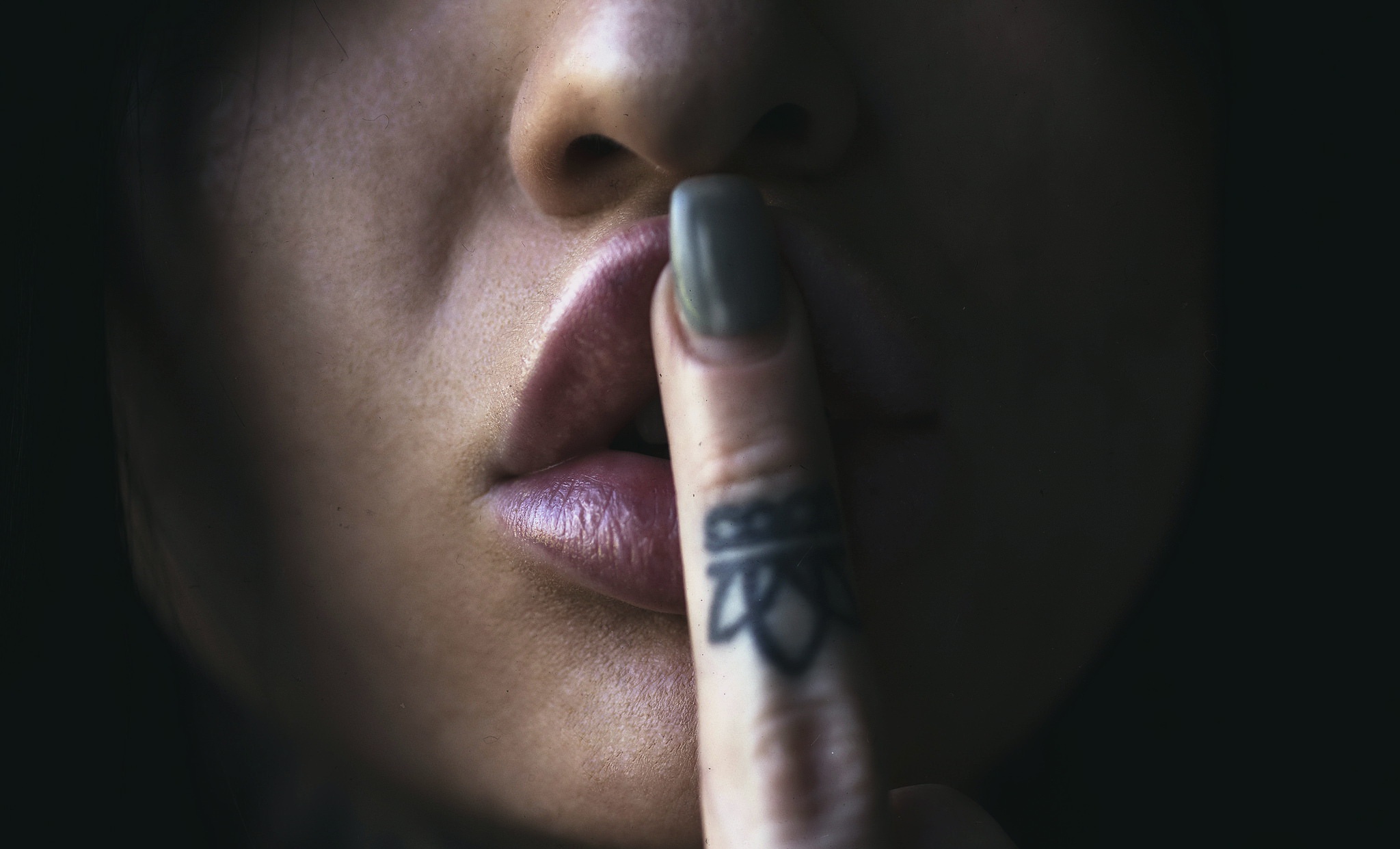 Woman with Finger Tattoo Silencing HD Wallpaper