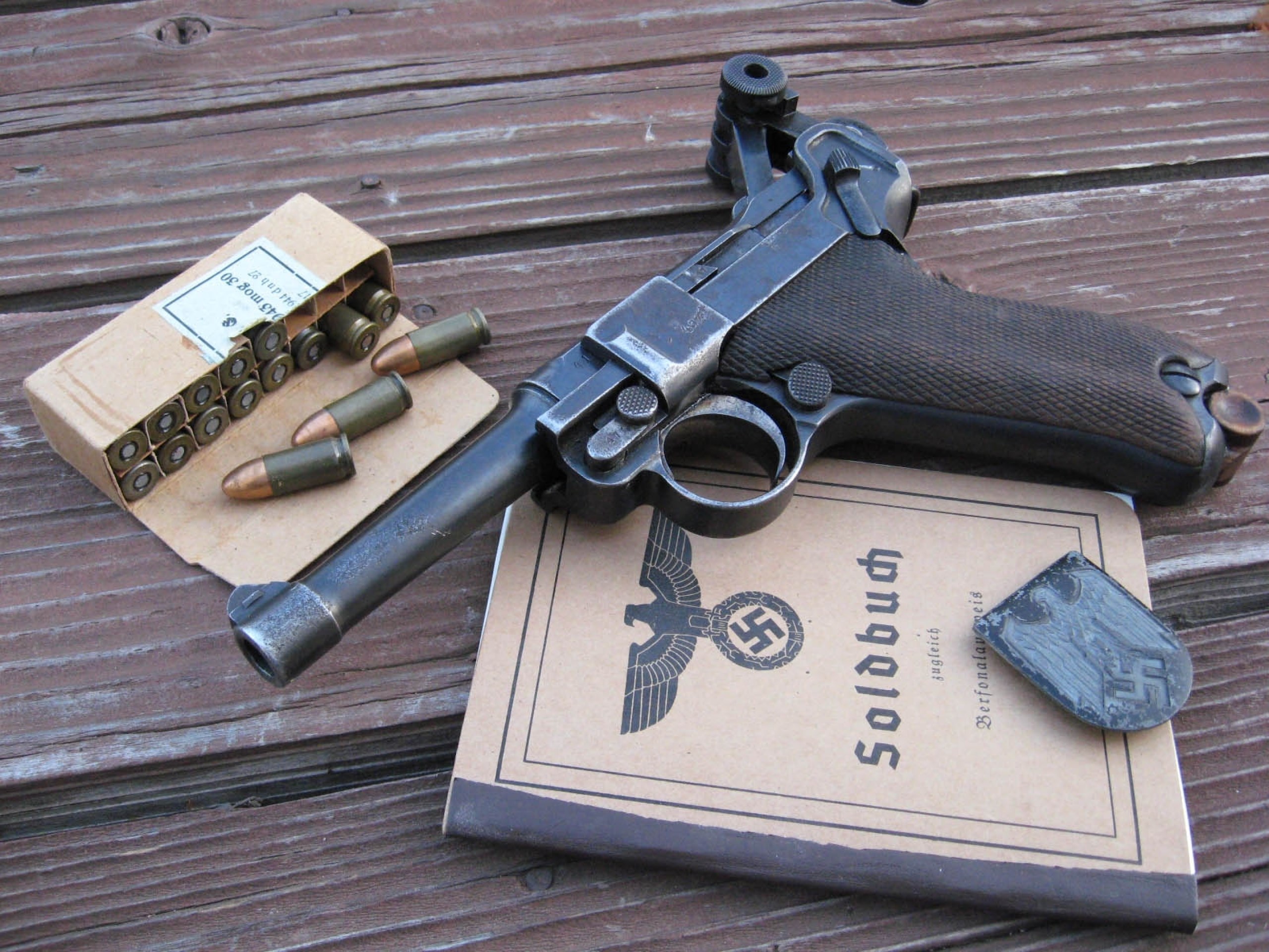 Luger pistol with ammunition and German documents HD Wallpaper