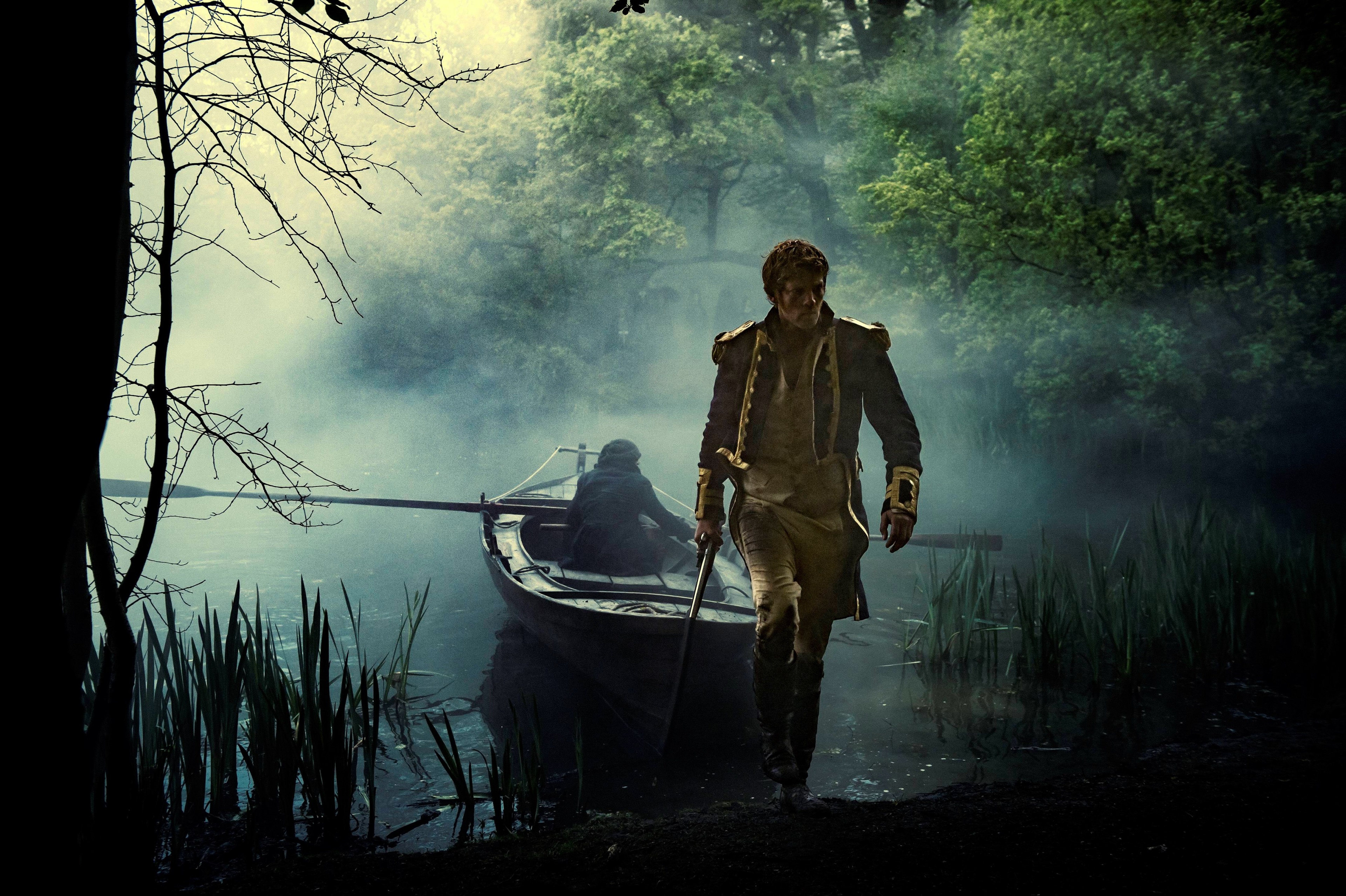 Man in military uniform by a boat HD Wallpaper