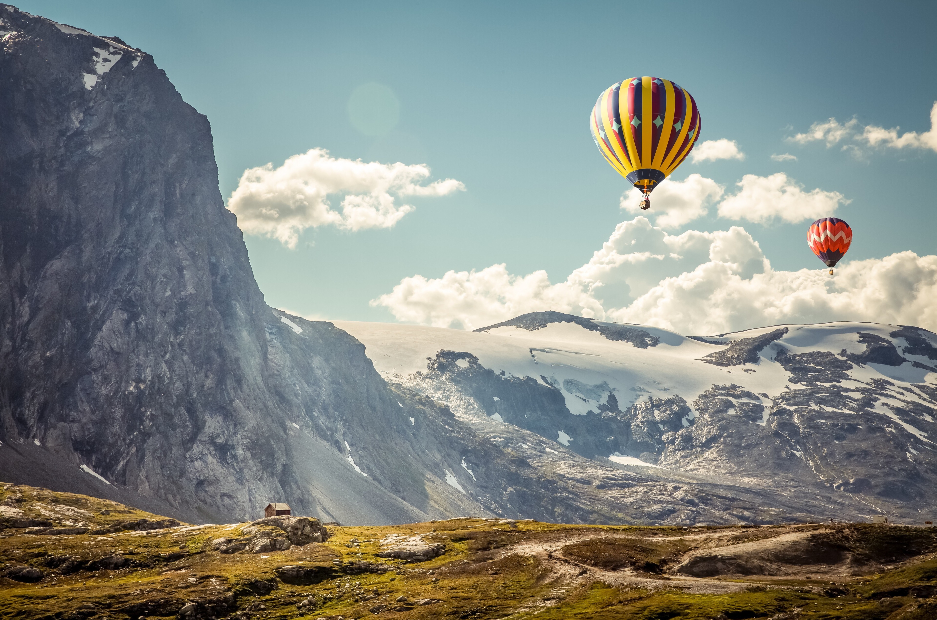 Hot air balloons over snowy mountains in Iceland 4K HD Wallpaper