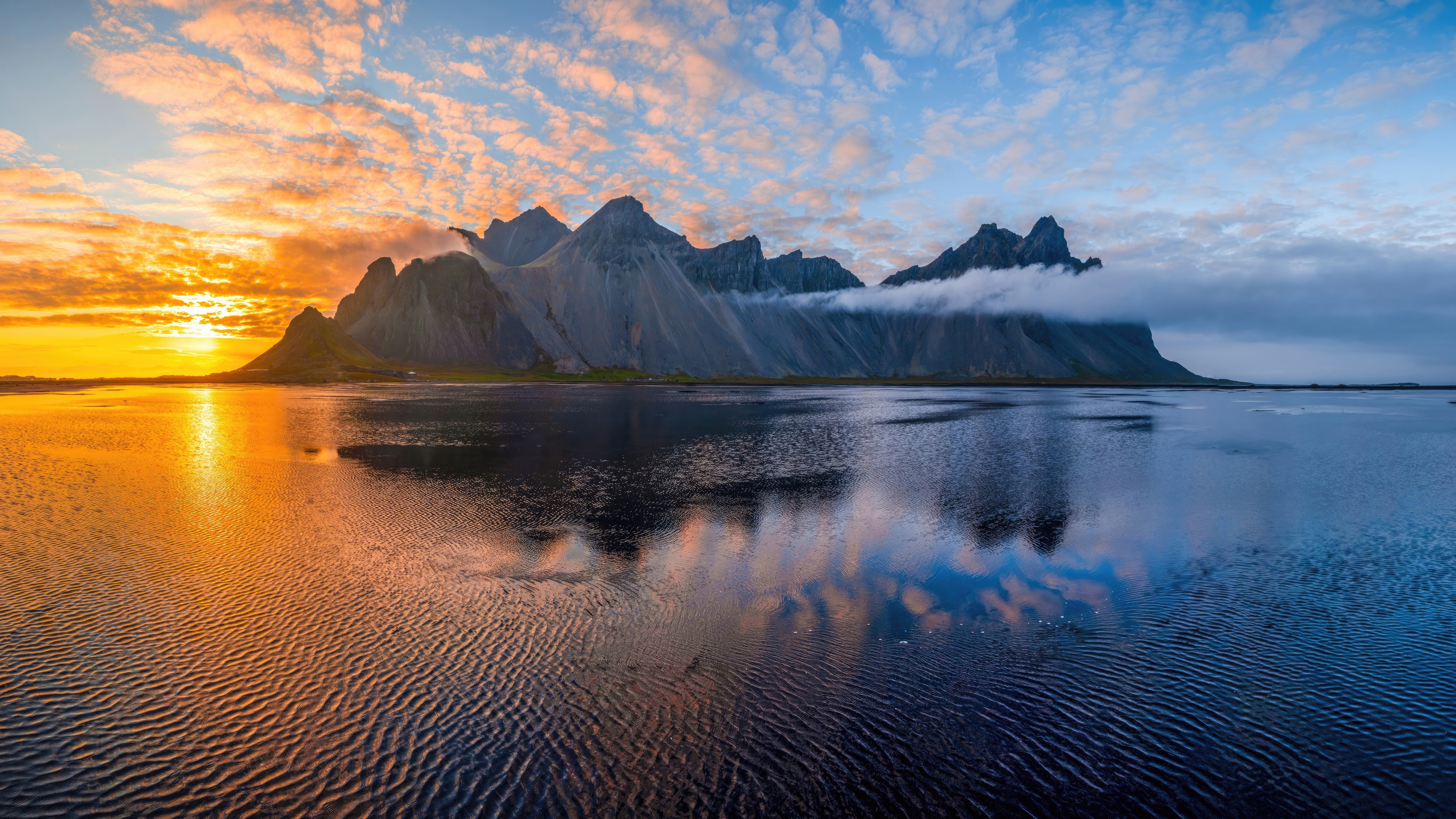 Mountain range reflected in the sea at sunset HD Wallpaper