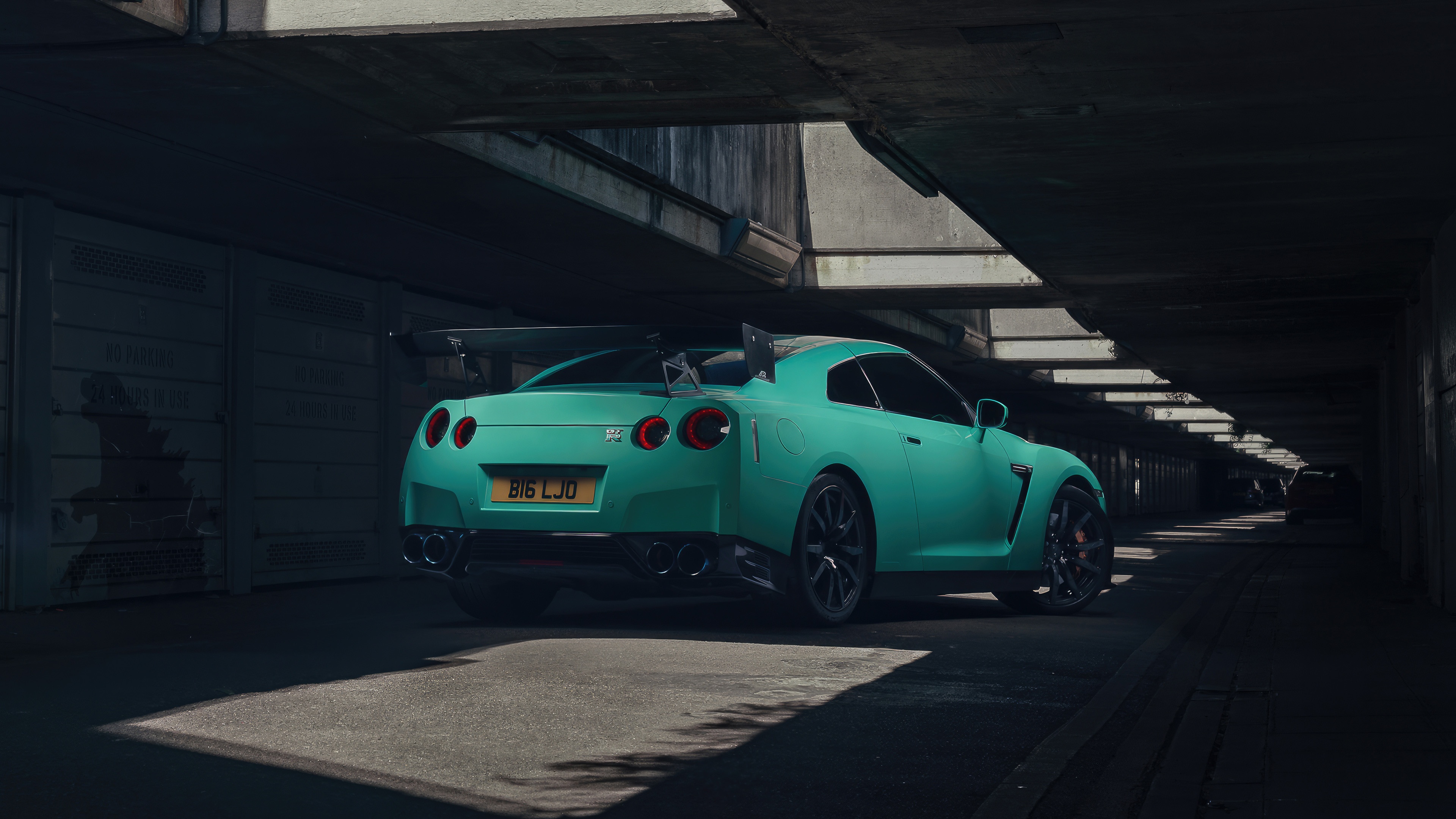 Teal Nissan R35 GT-R parked under a bridge HD Wallpaper