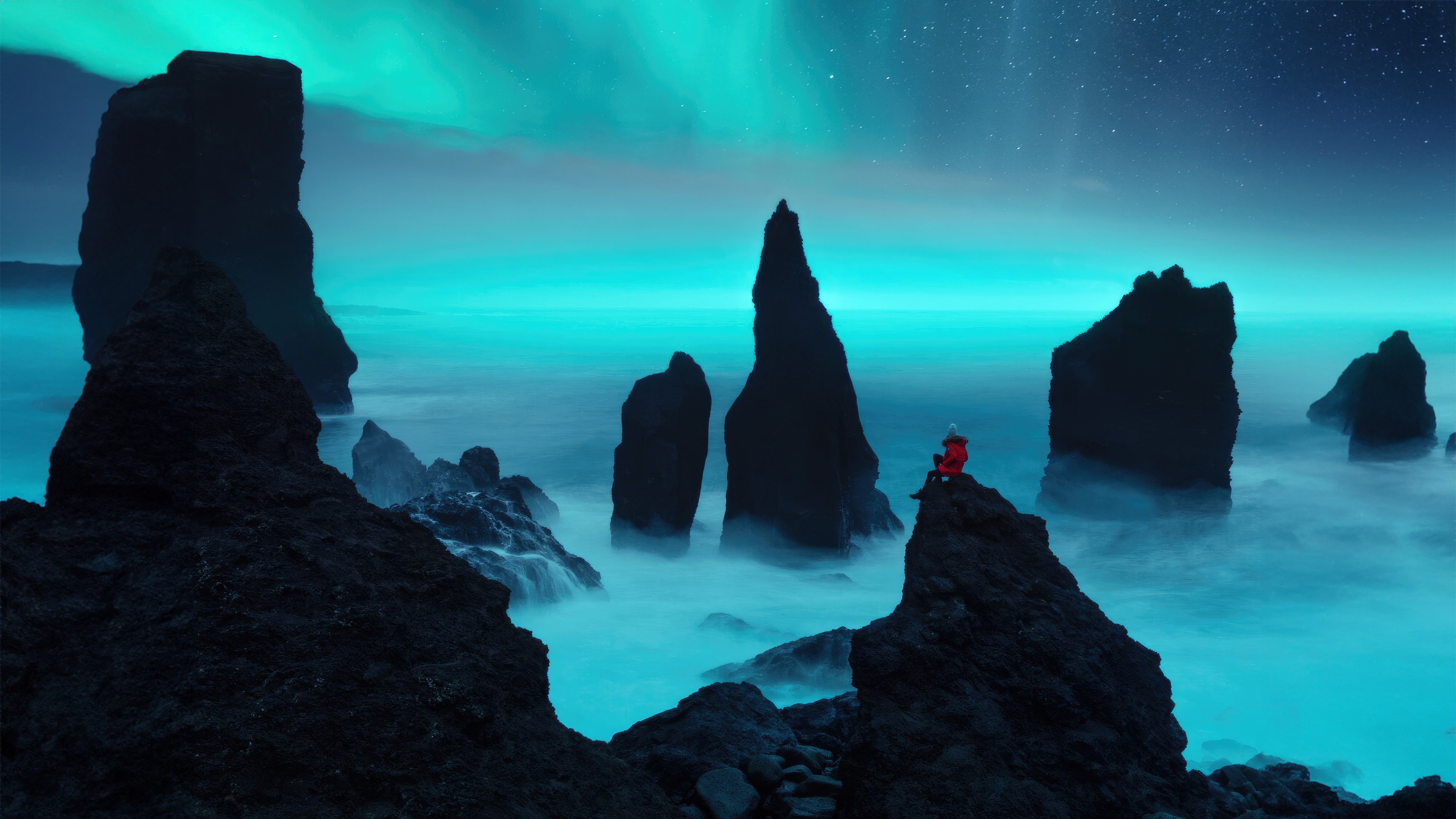 Person sitting on rocks under Aurora Borealis HD Wallpaper