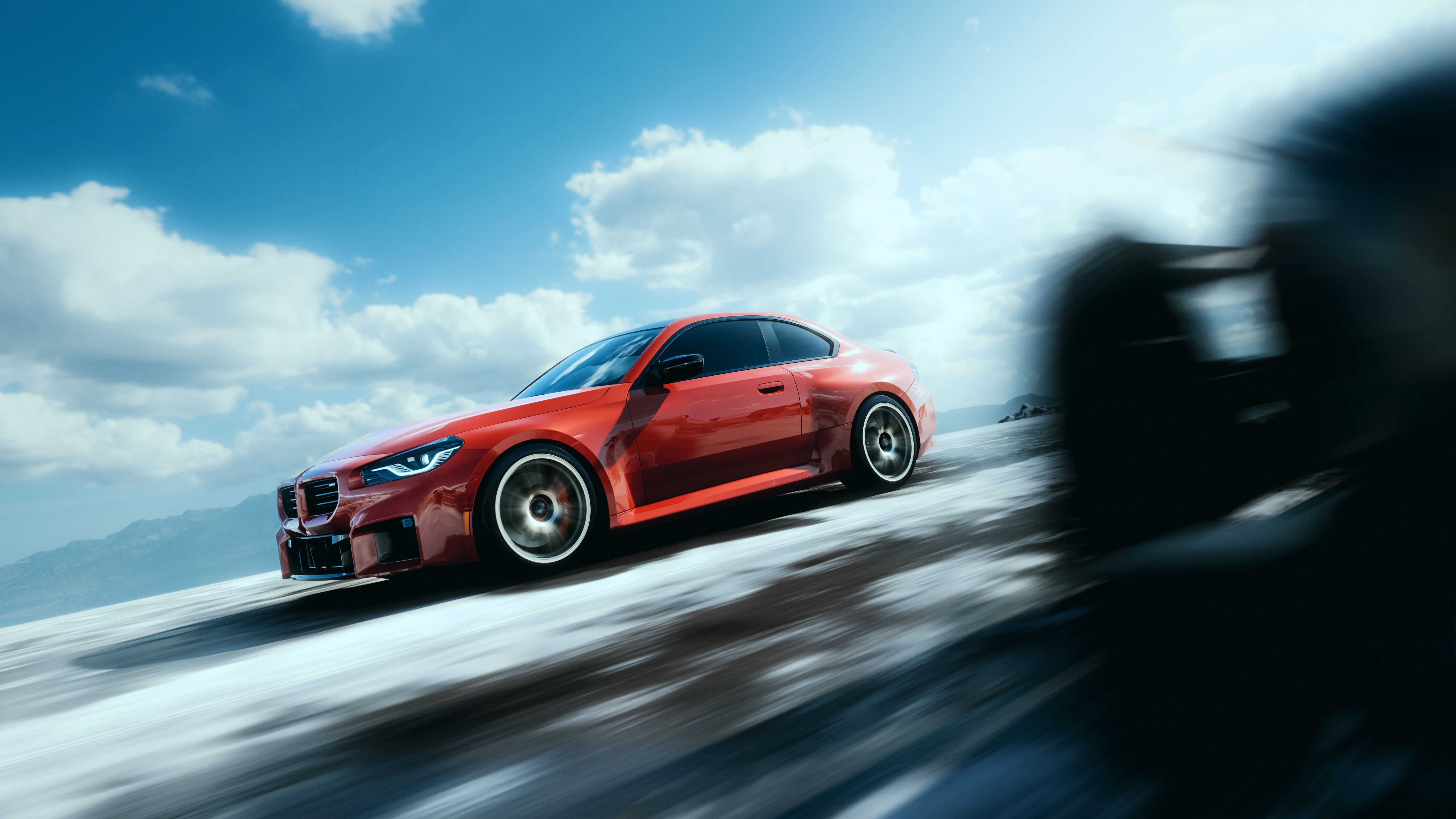 Red BMW M2 driving on a snowy road HD Wallpaper