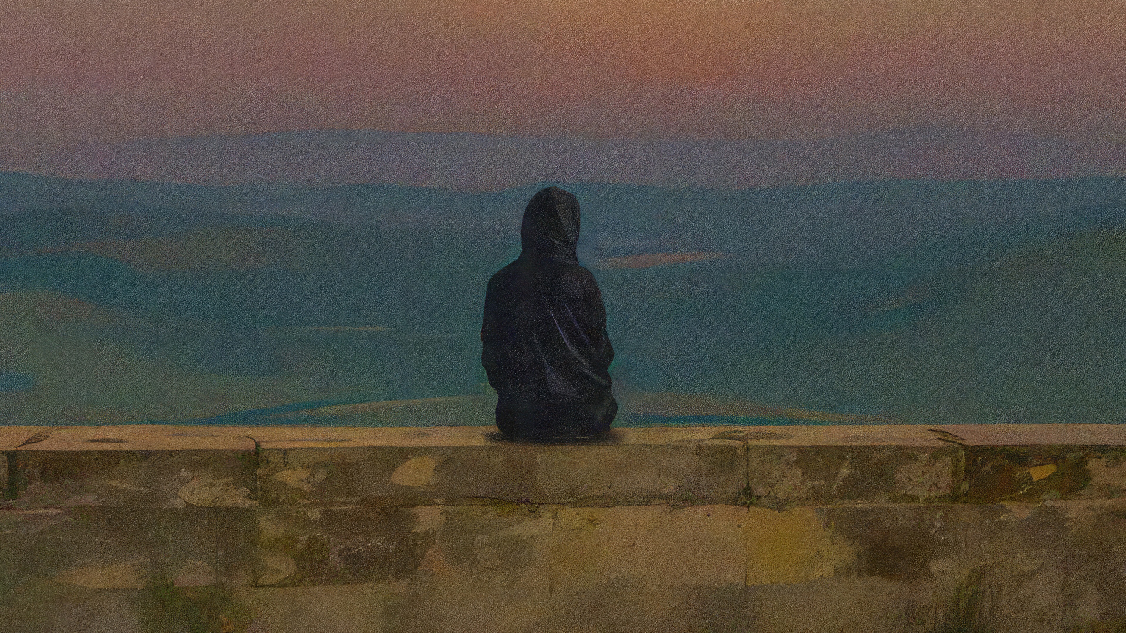 Person in hoodie sitting on wall overlooking landscape HD Wallpaper
