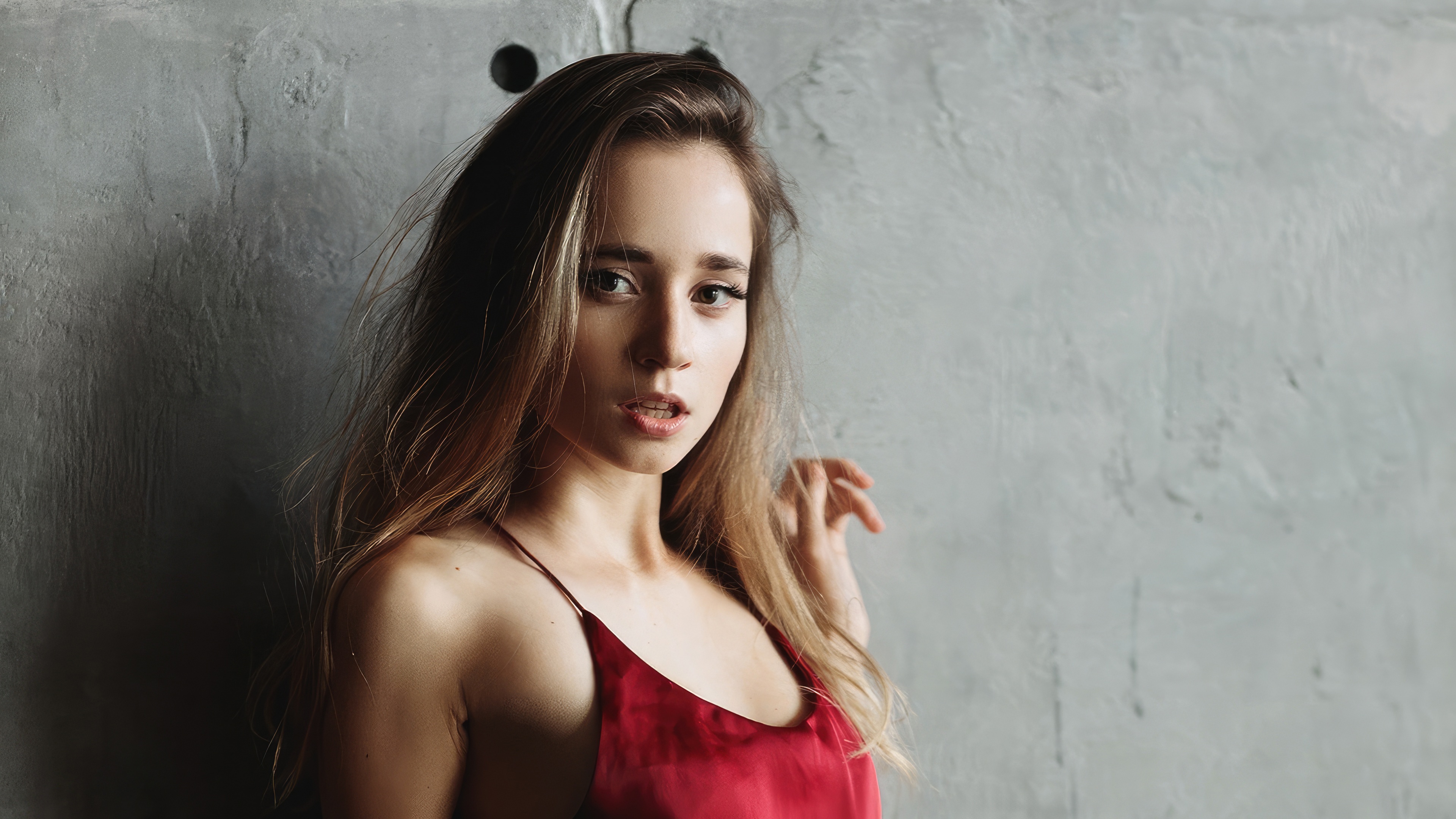 Blonde woman in a red dress against a concrete wall HD Wallpaper