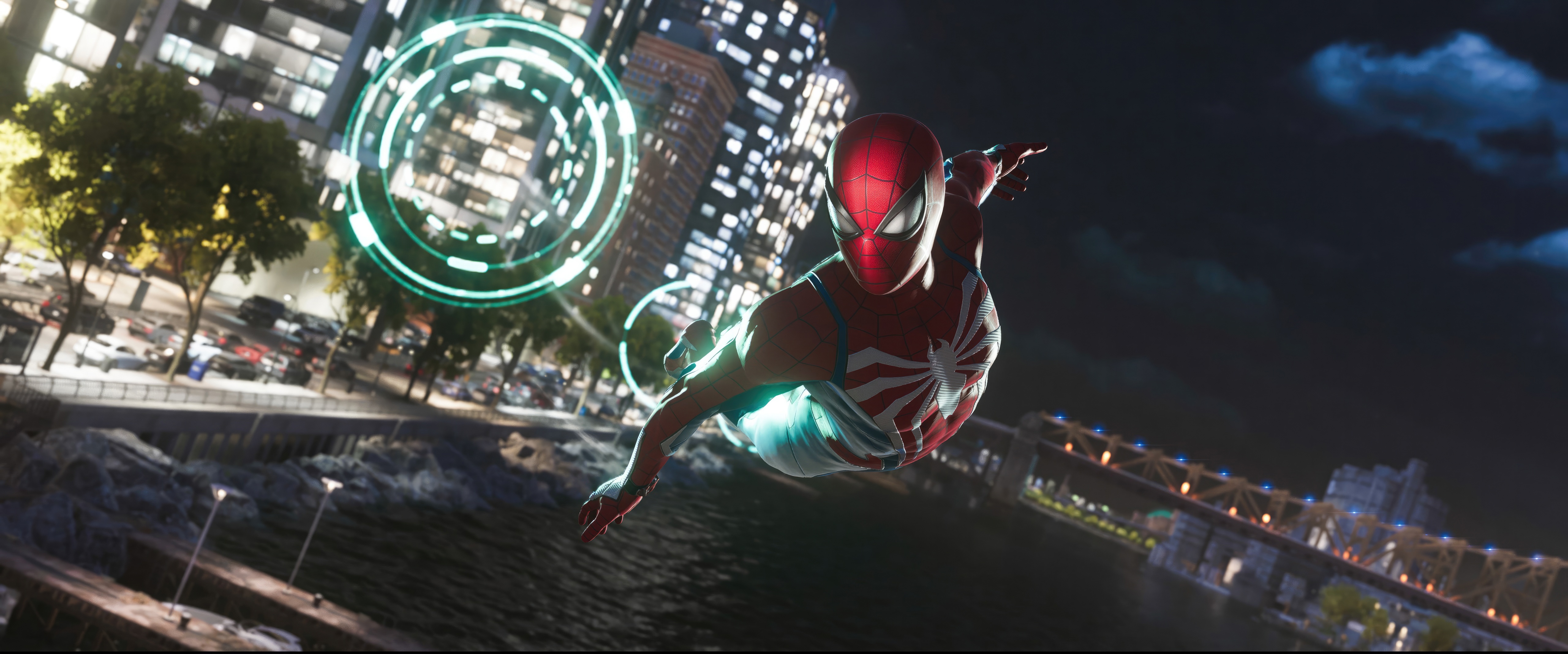 Spider-Man swings through a city at night HD Wallpaper