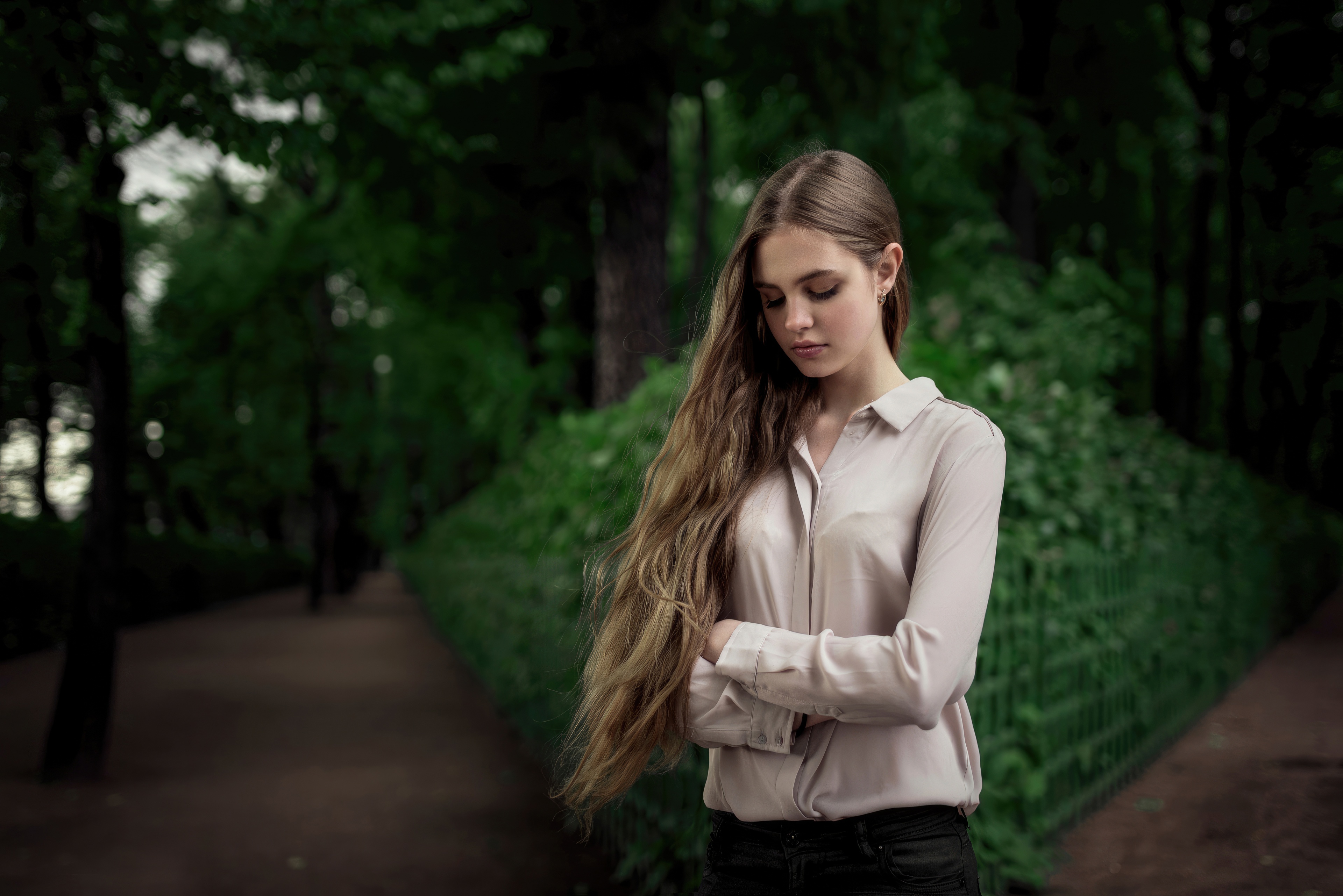 Blonde girl lost in thought in a park HD Wallpaper