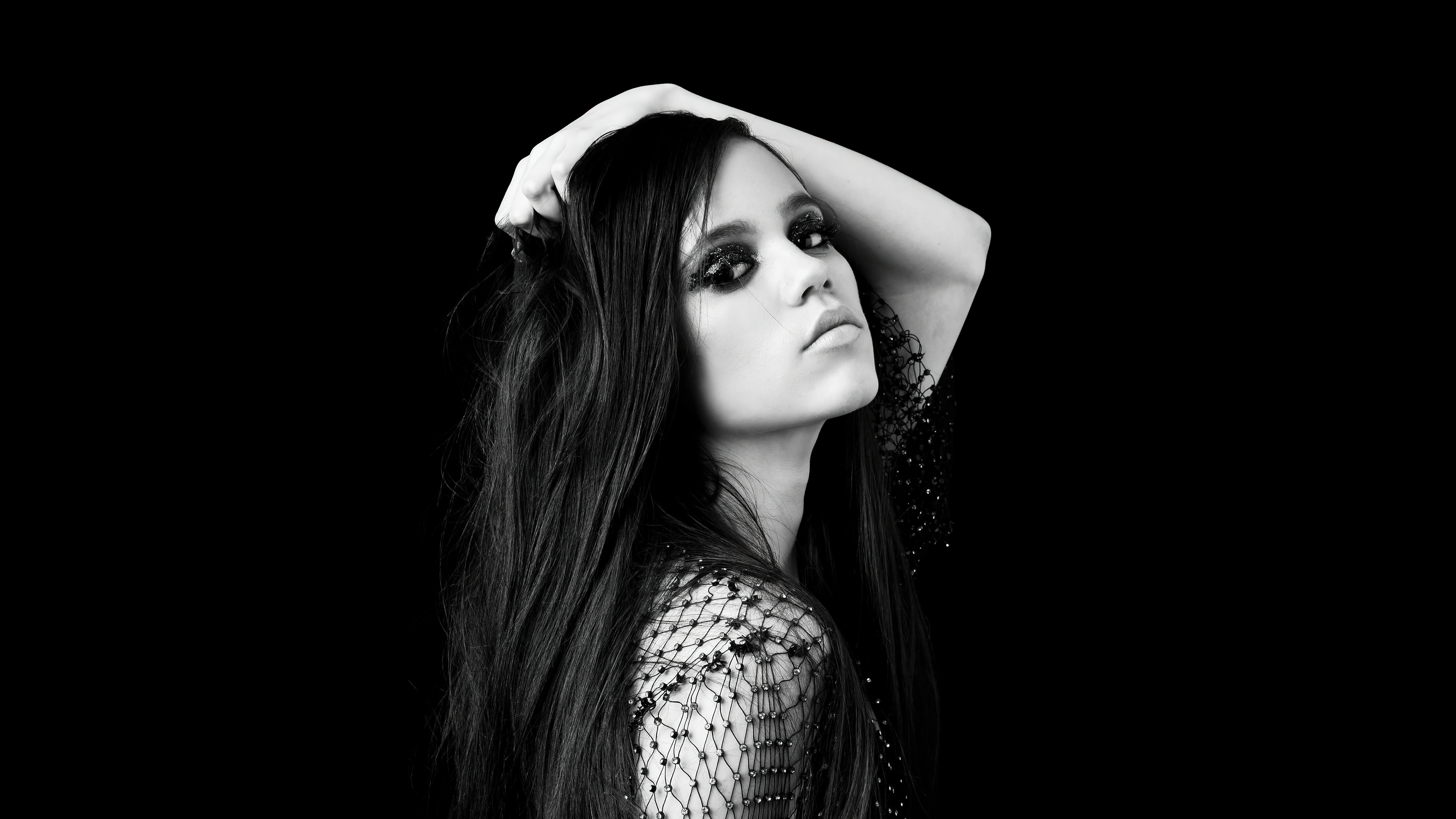 Jenna Ortega with dark eye makeup and mesh top HD Wallpaper