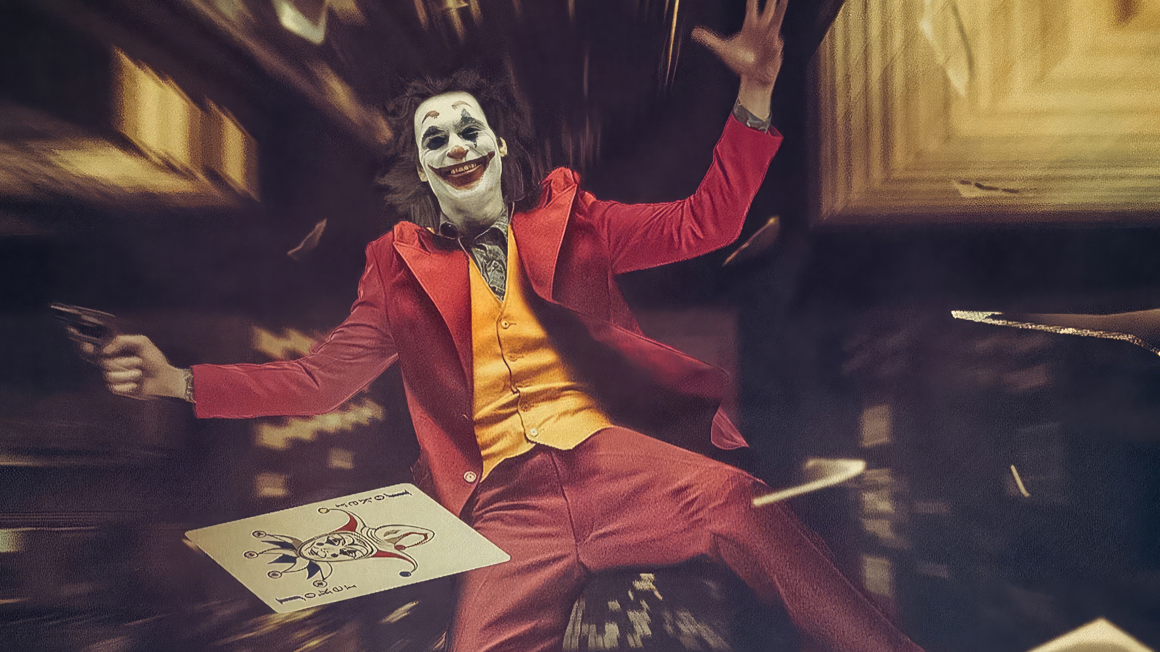 Joker falling with a gun and card HD Wallpaper