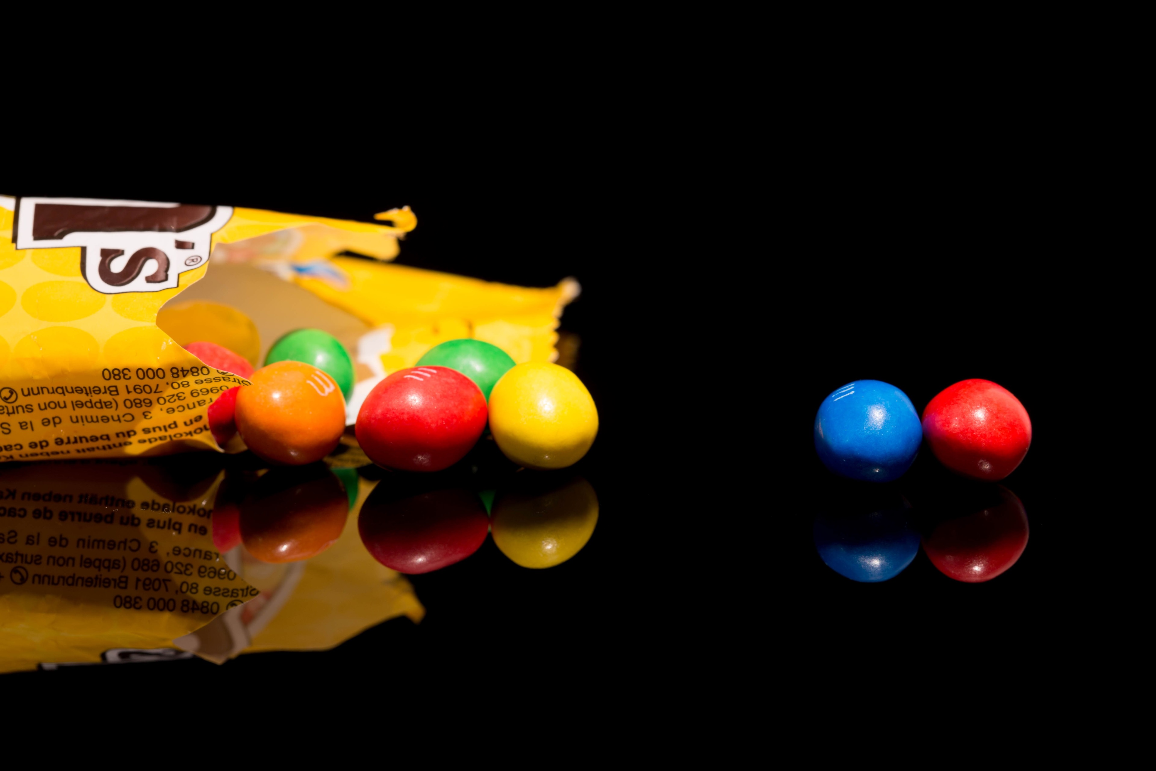 M&M's candies spilling from a bag HD Wallpaper
