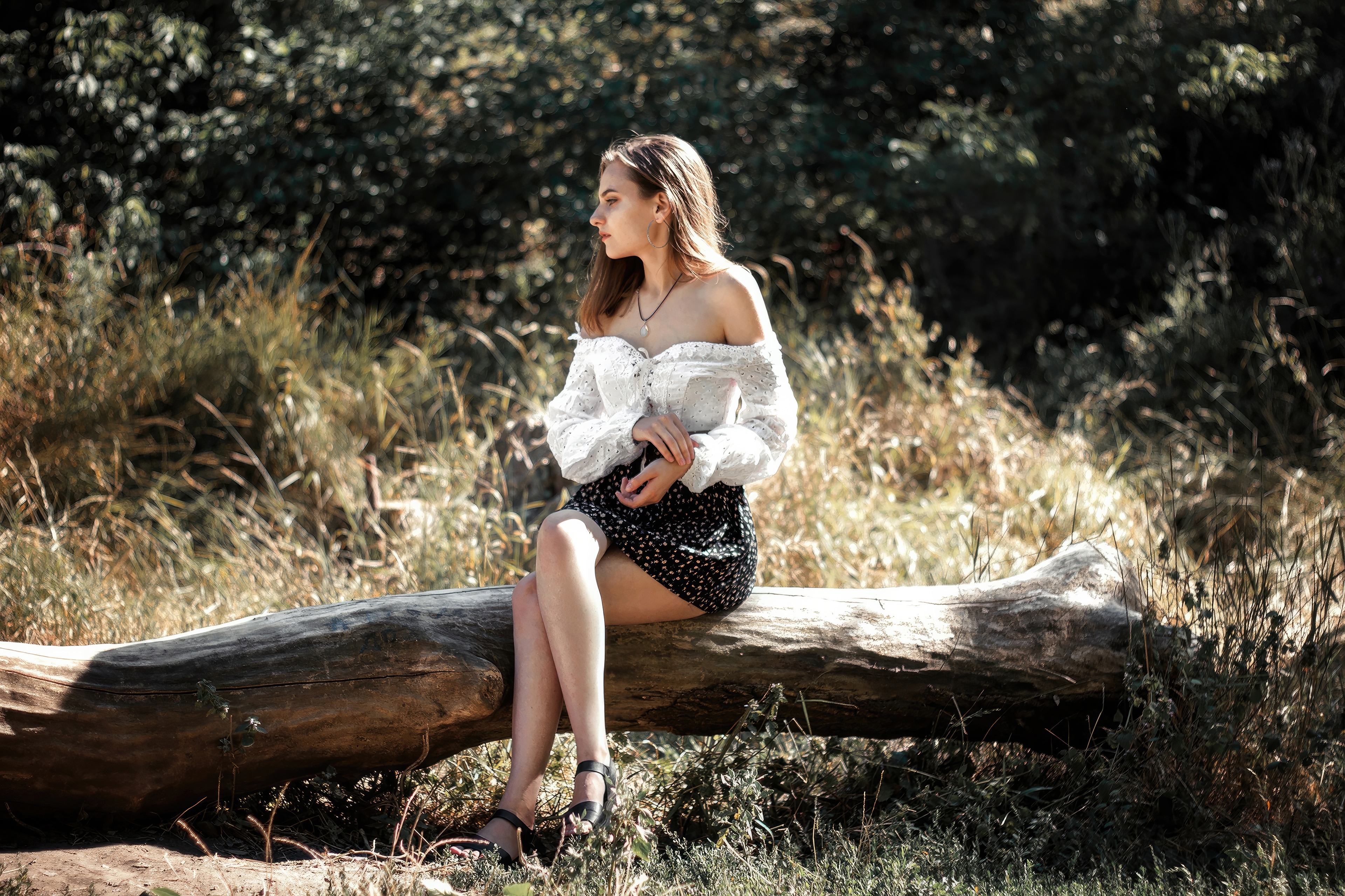 Girl Sitting on a Log in a Forest HD Wallpaper