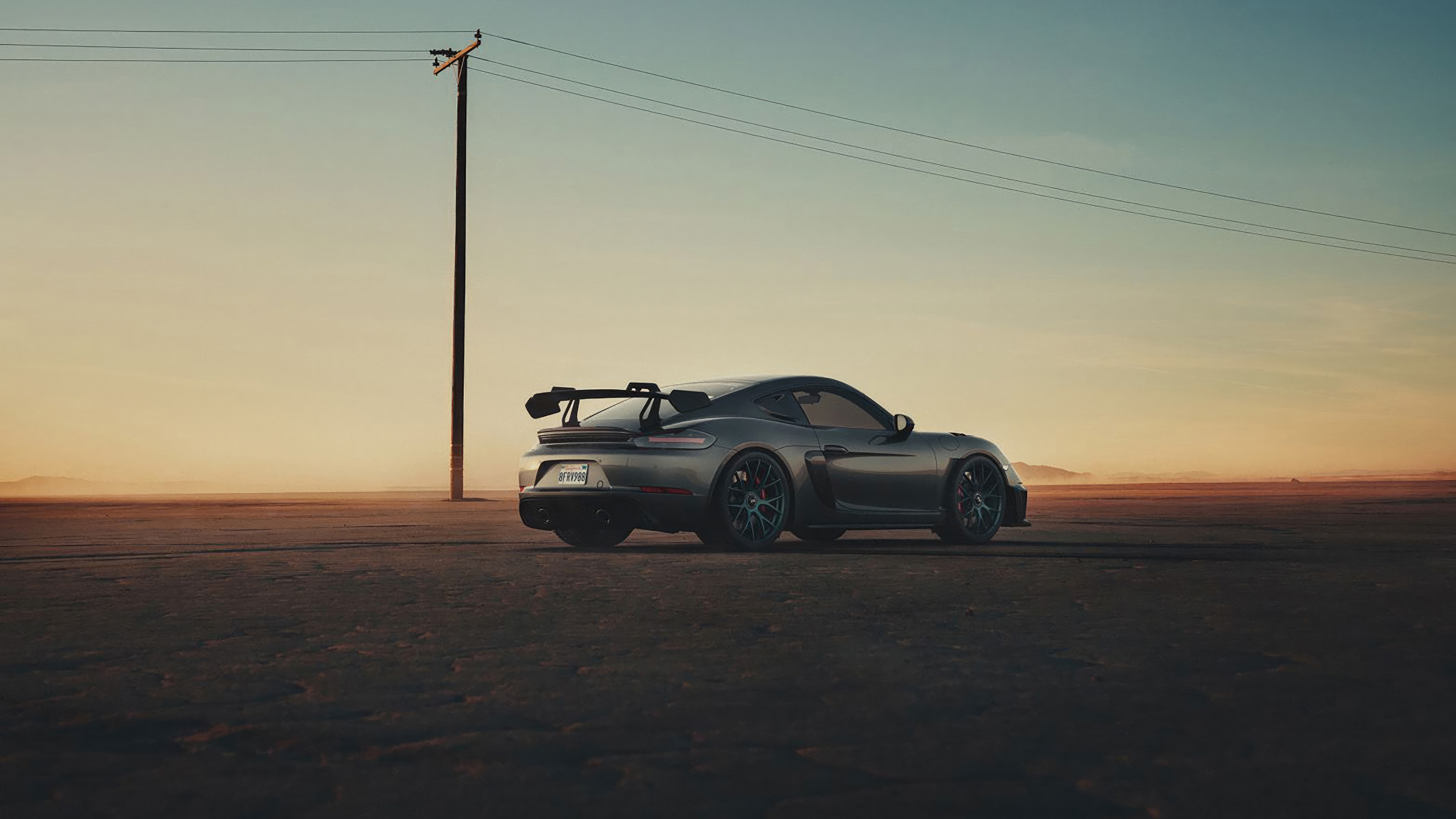 Porsche 718 Cayman GT4 RS in a desert landscape HD Wallpaper