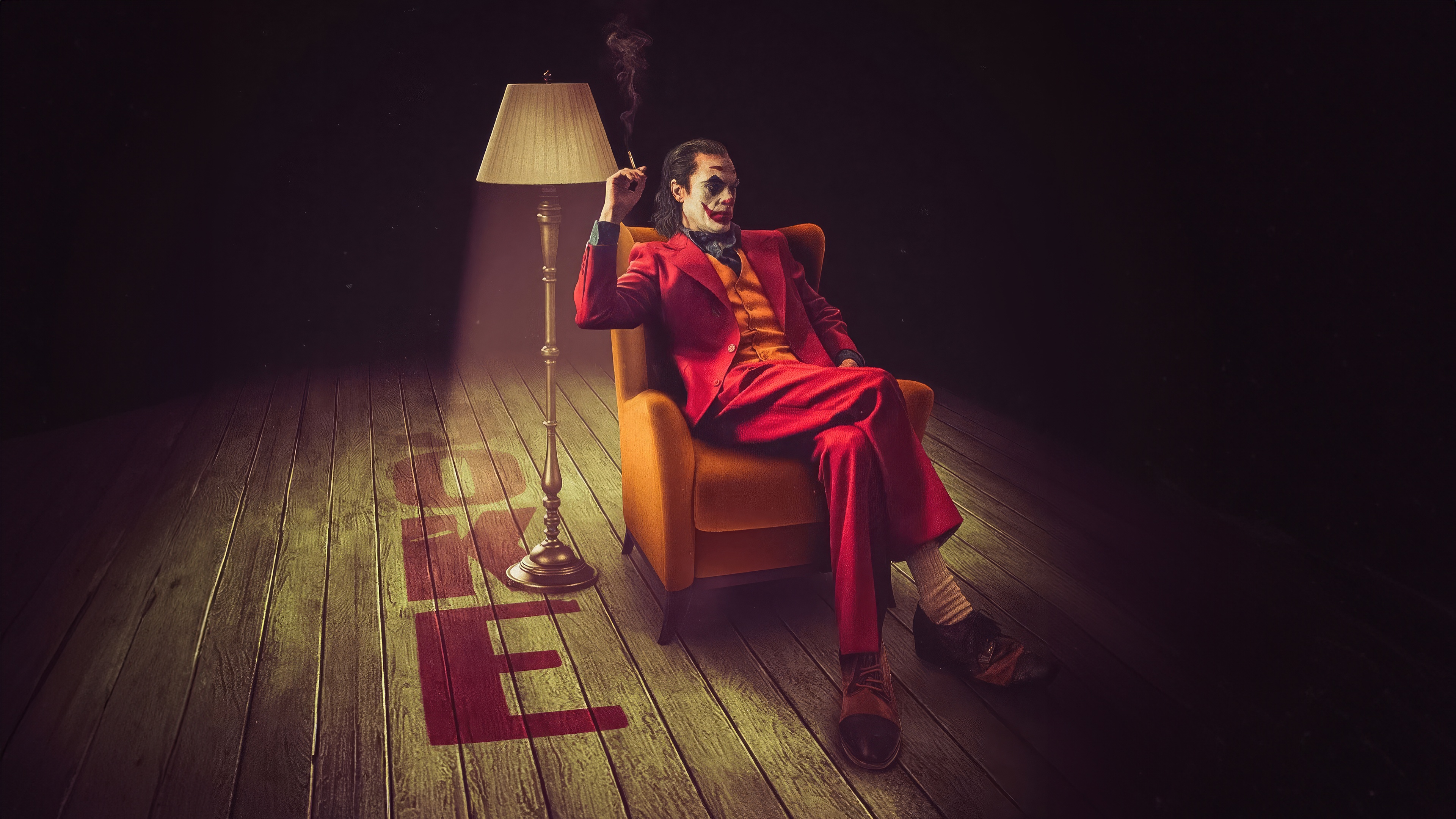 Joker Sitting in Chair Smoking HD Wallpaper