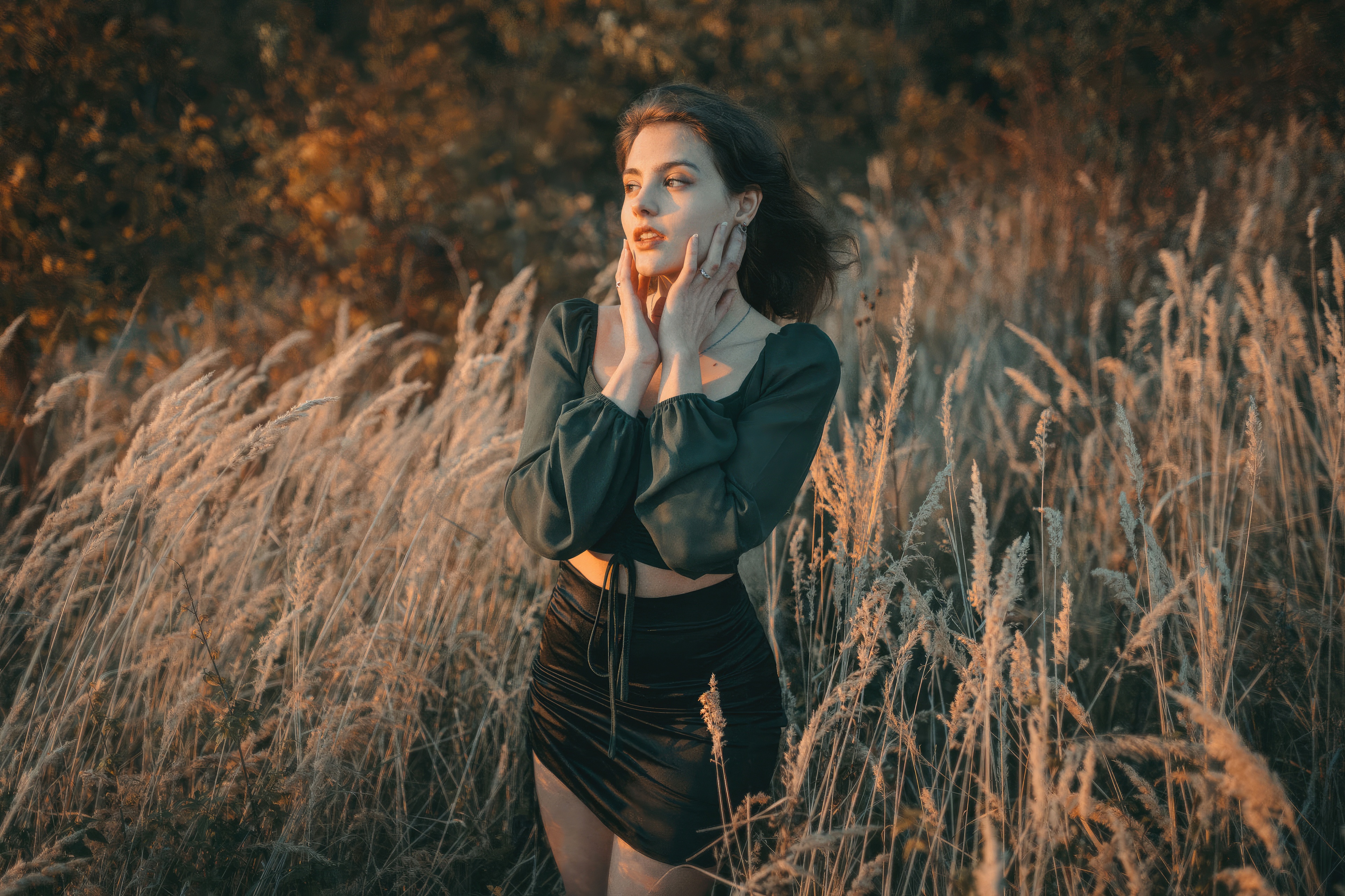 Woman with hands on face in tall grass HD Wallpaper