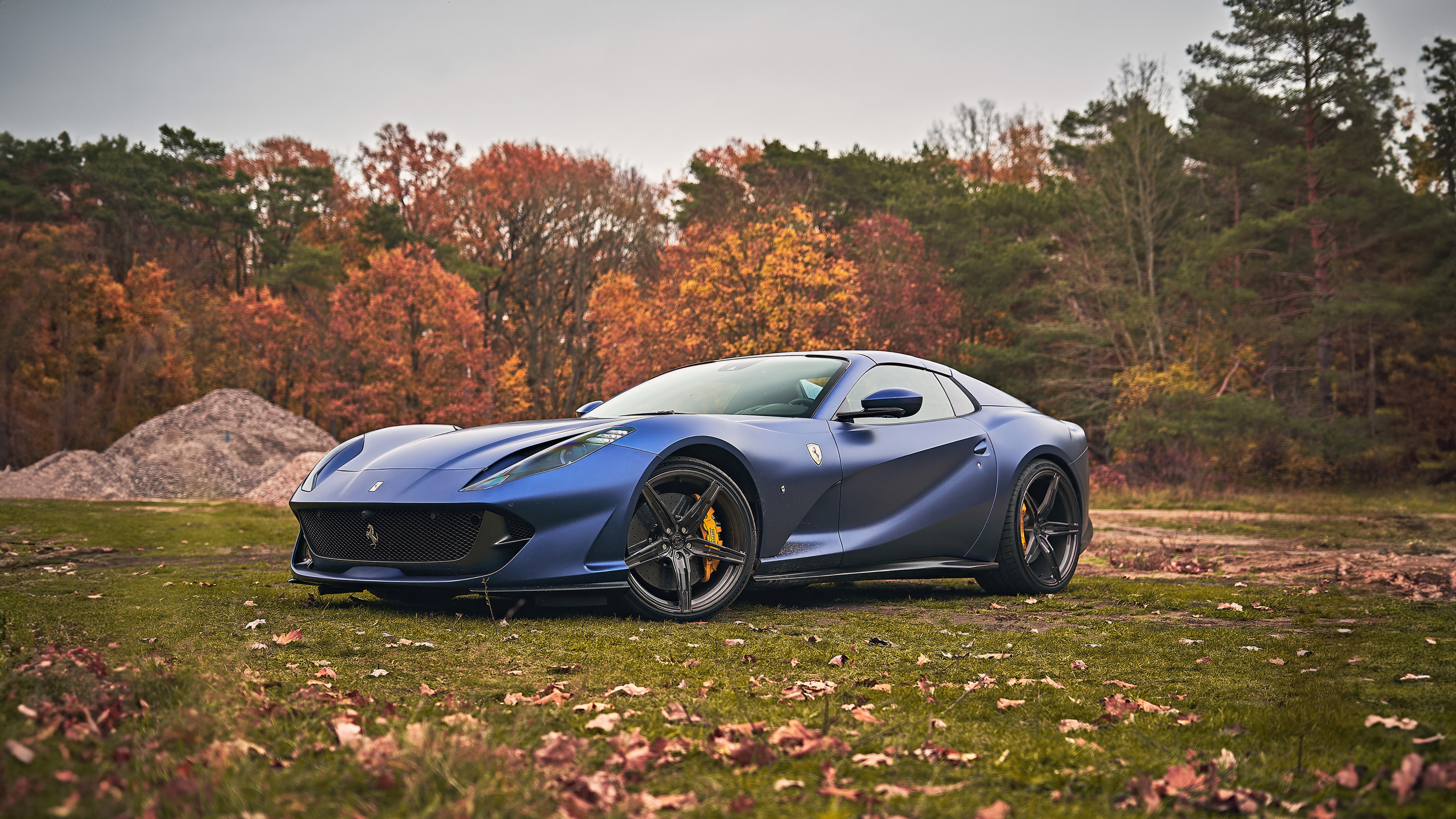 Blue Ferrari 812 GTS parked in autumn forest HD Wallpaper