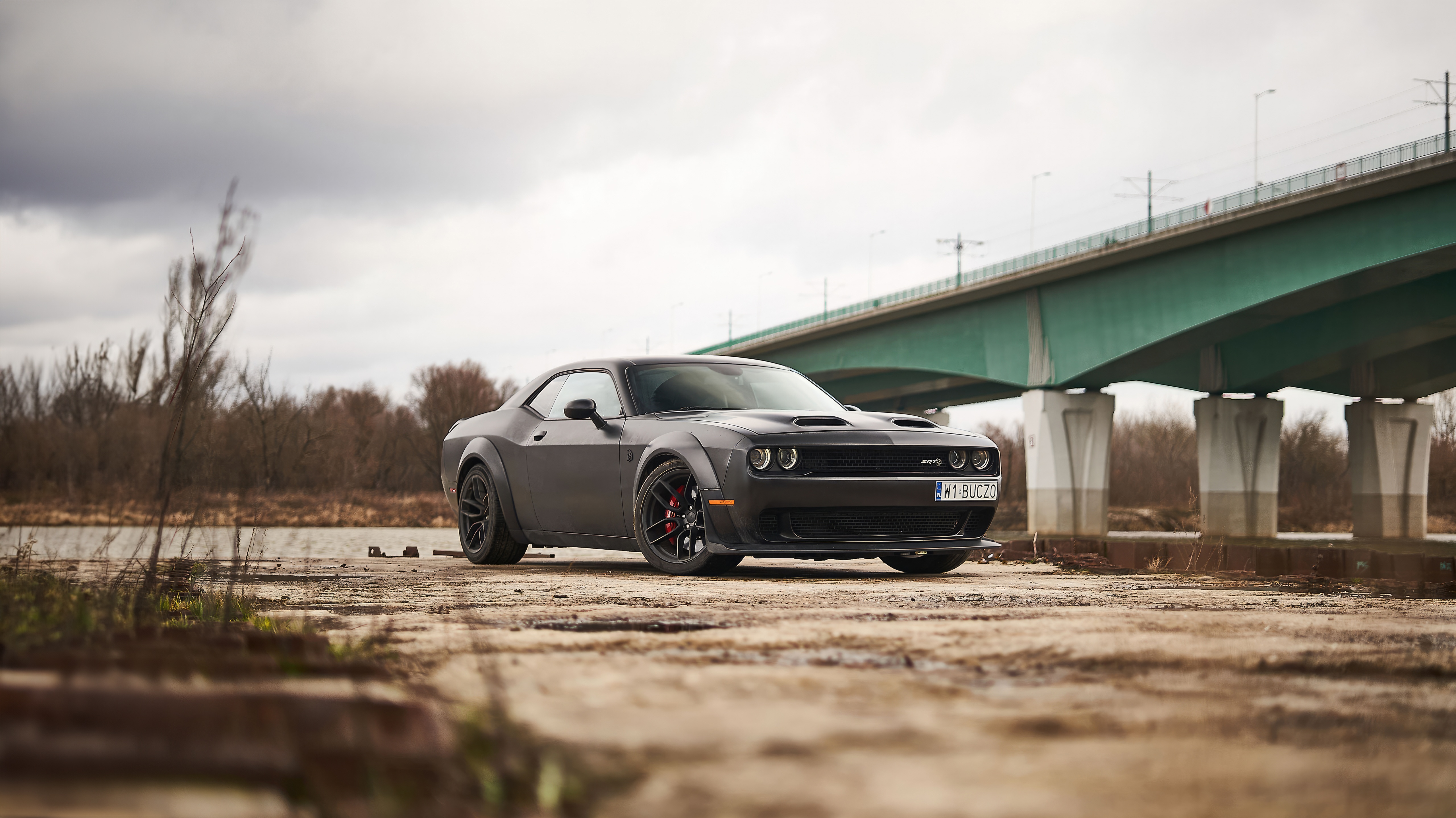 Black Dodge Challenger parked under a bridge HD Wallpaper