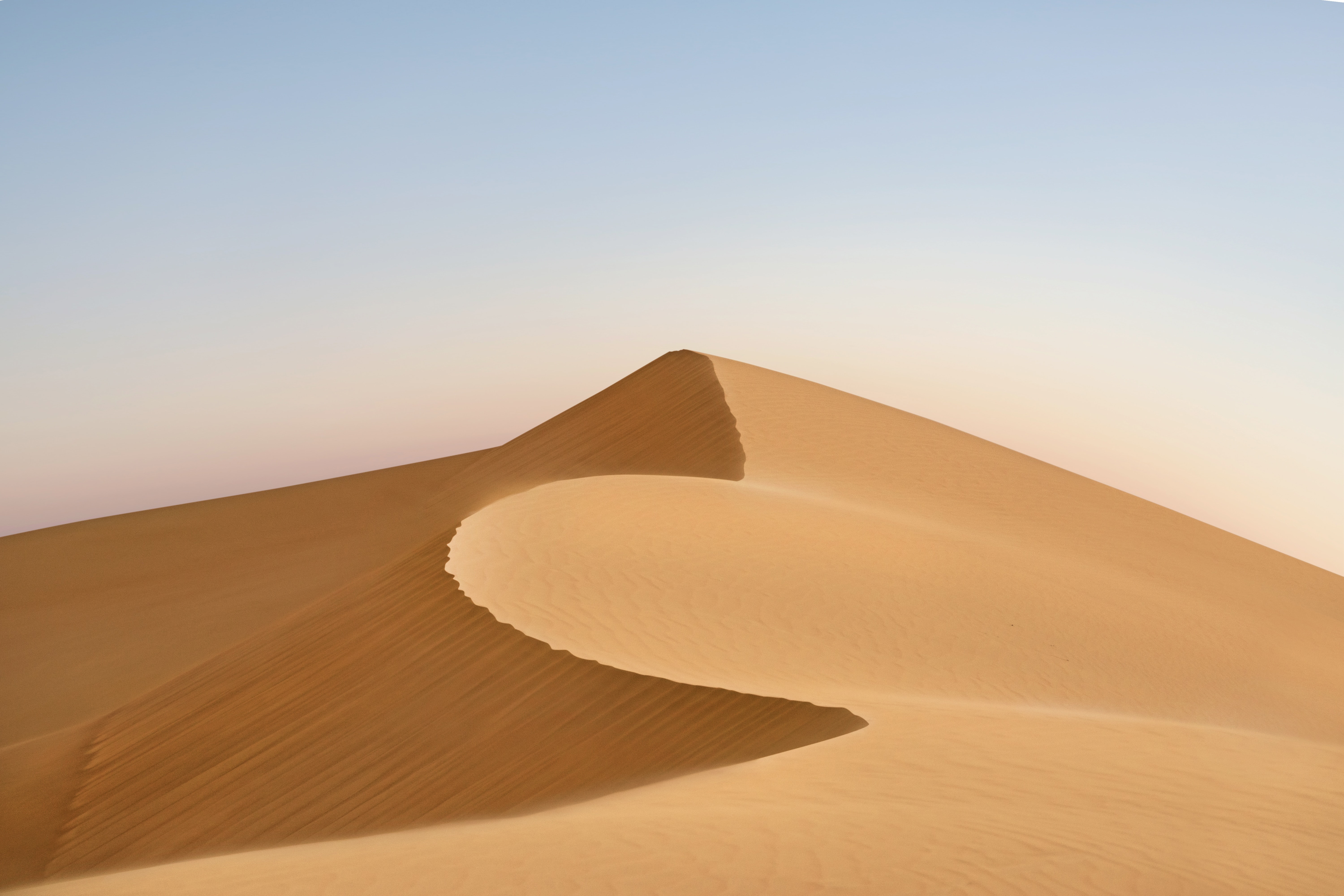 Desert dunes under a clear sky HD Wallpaper