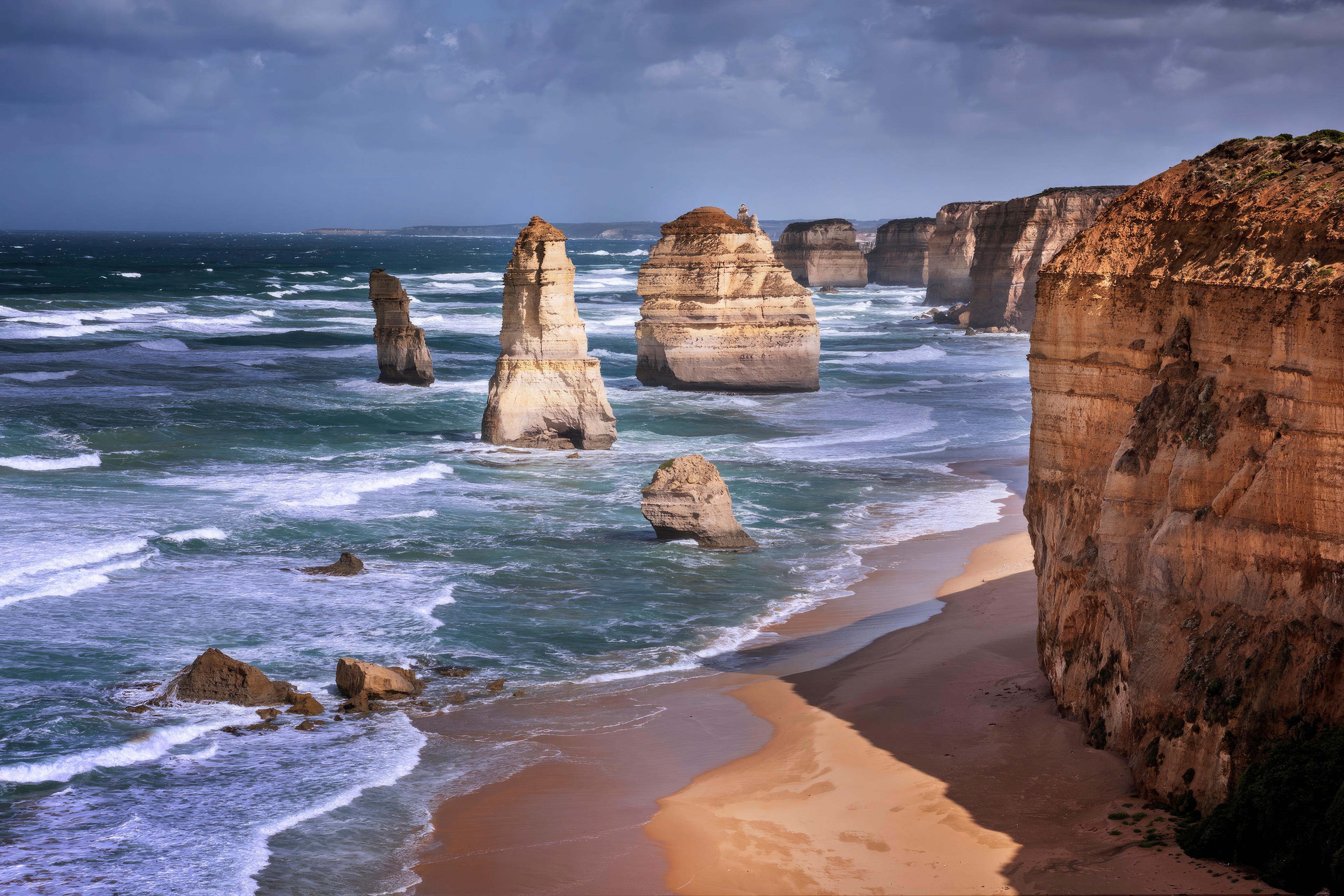 The Twelve Apostles rock formations on a stormy day HD Wallpaper