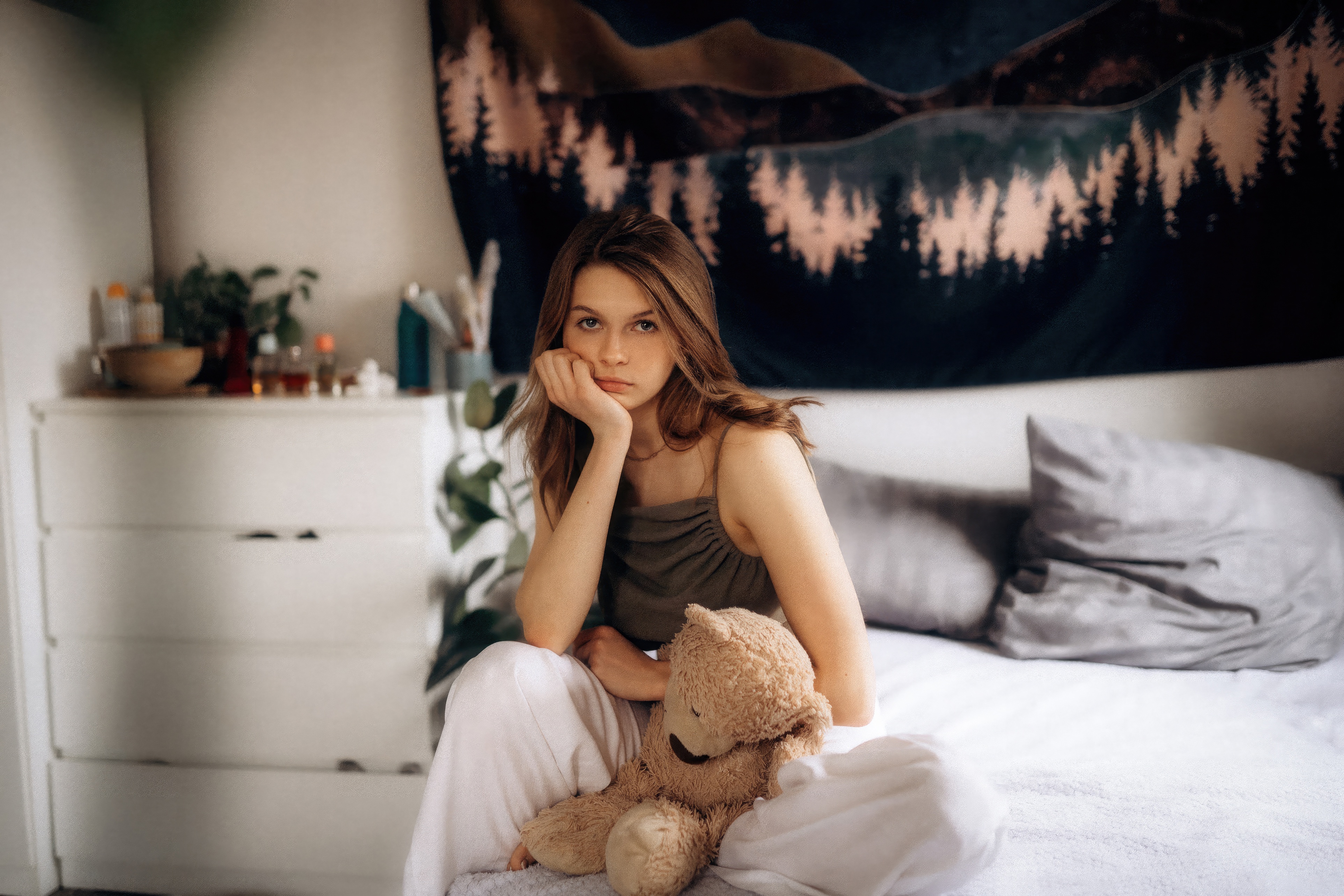 Girl with teddy bear sitting on a bed HD Wallpaper