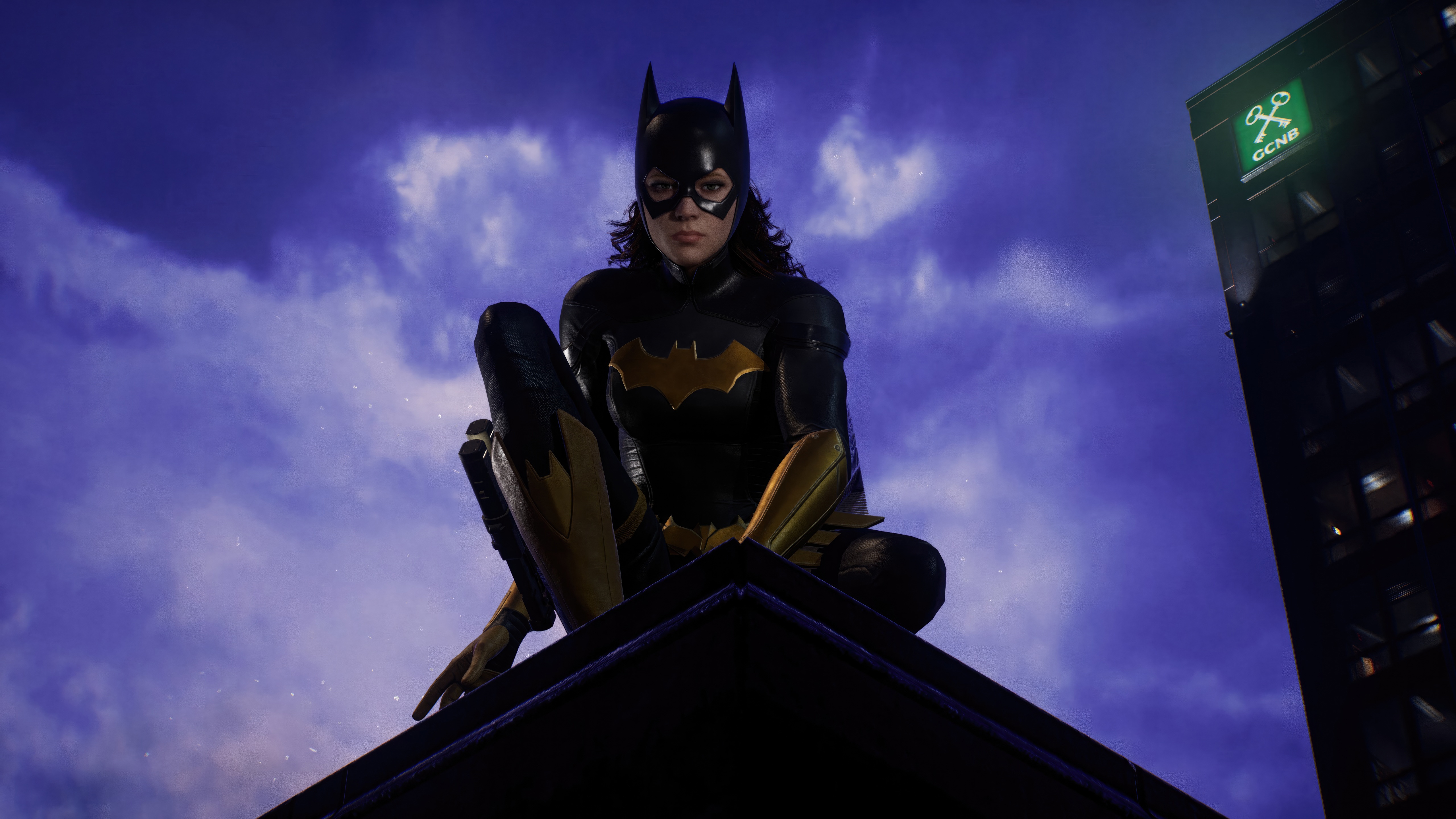 Batgirl perched on a rooftop in Gotham HD Wallpaper