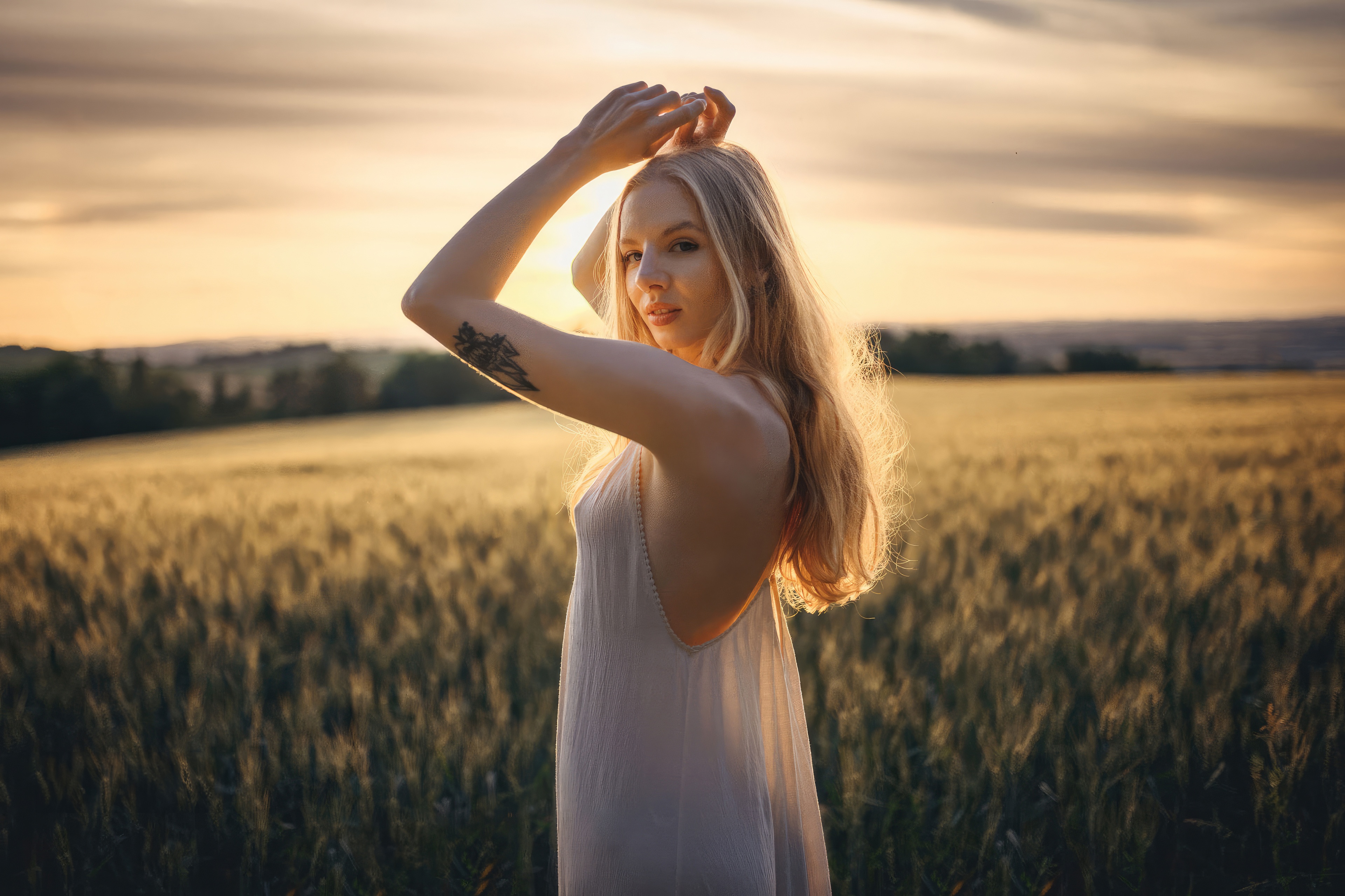 Girl in a white dress in a sun-drenched field HD Wallpaper