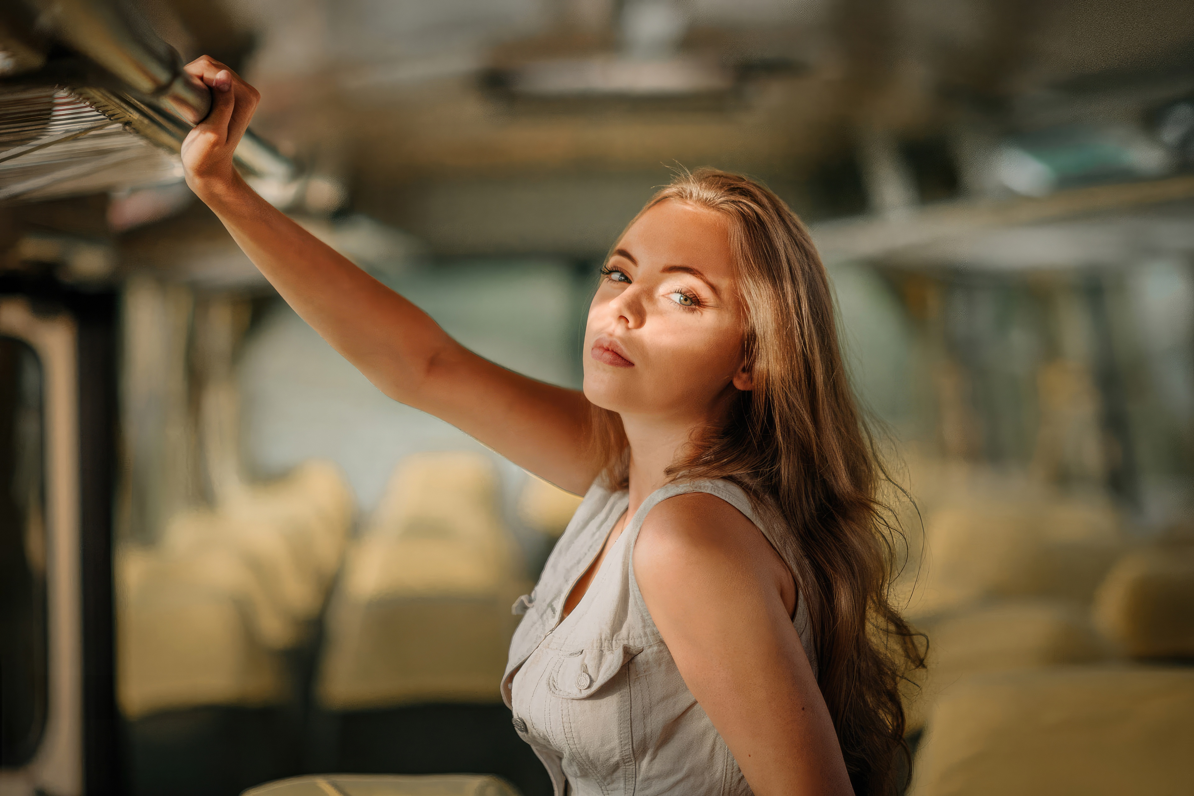 Woman holding onto a bar inside a bus HD Wallpaper