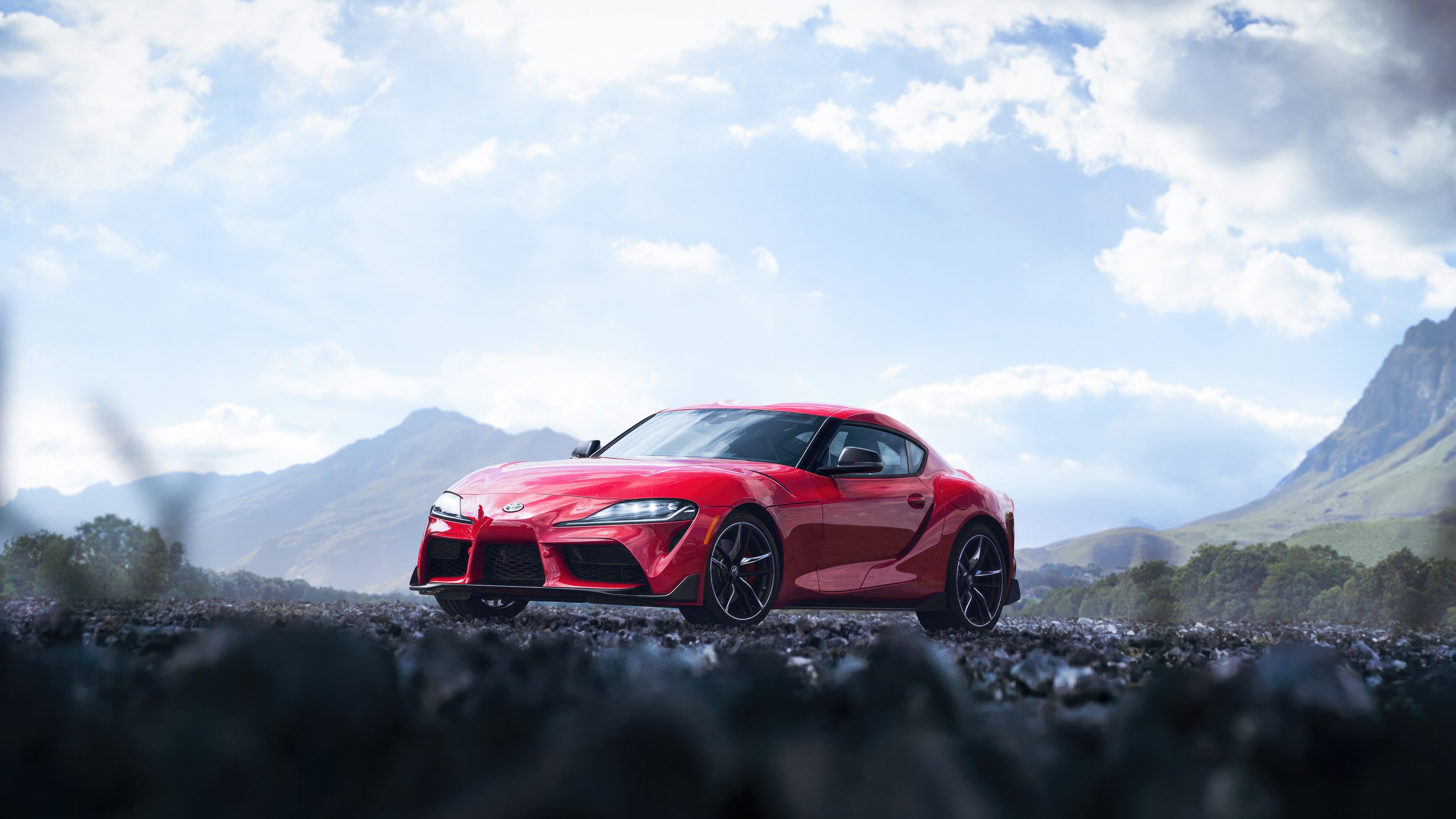 Red Toyota Supra on a rocky mountain road HD Wallpaper