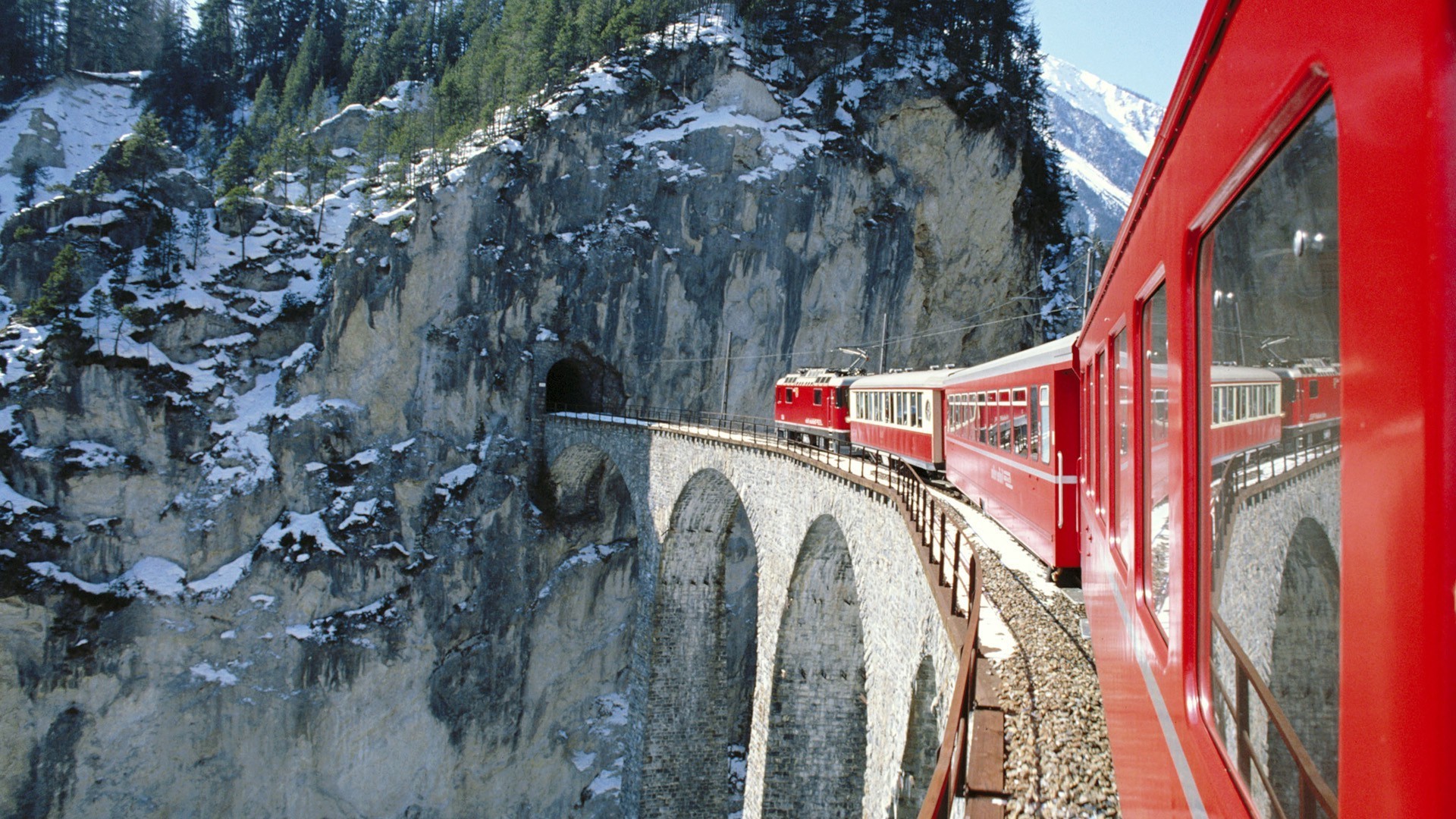 Red train on a viaduct in the Swiss Alps HD Wallpaper