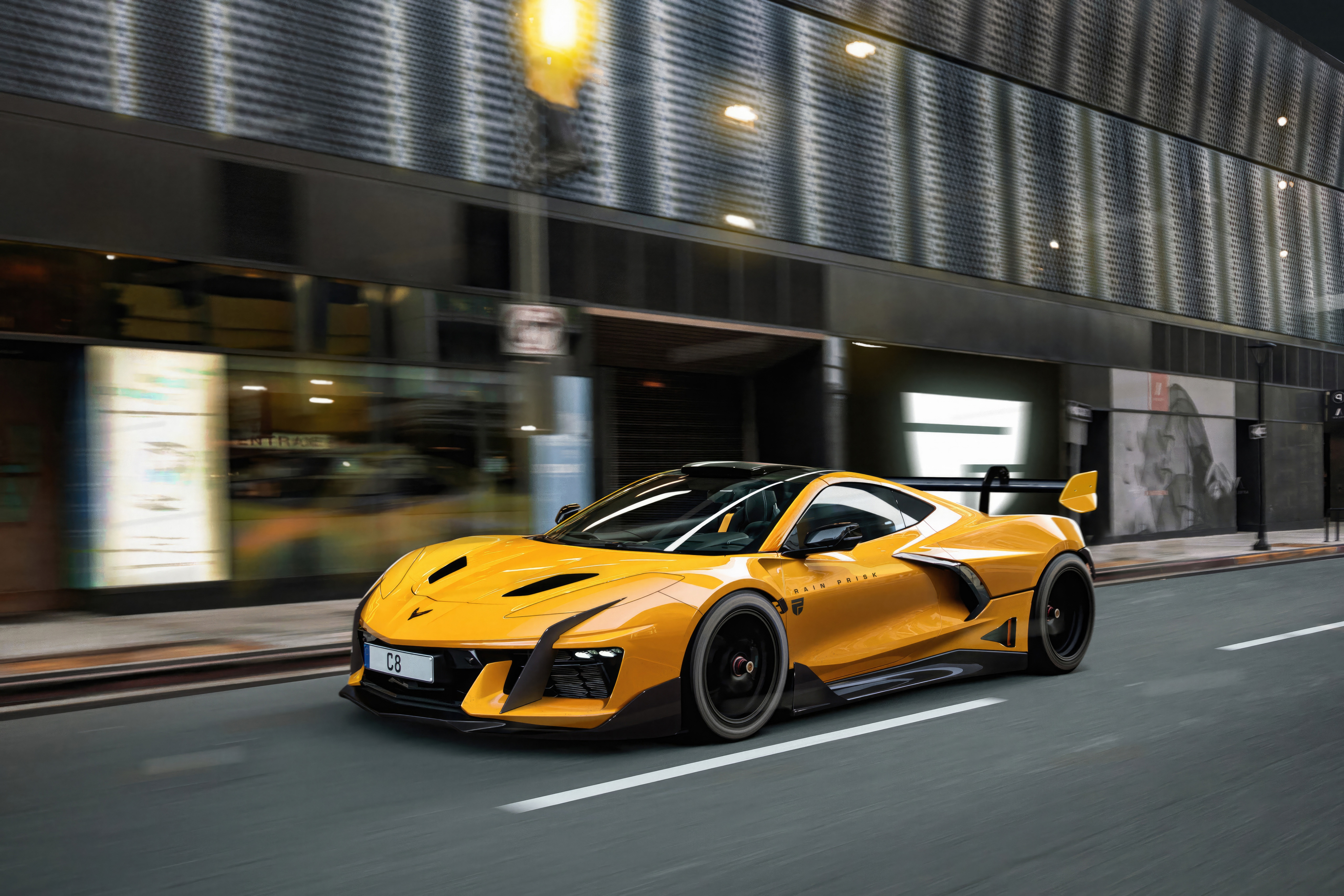 Yellow Corvette C8 driving on city street HD Wallpaper