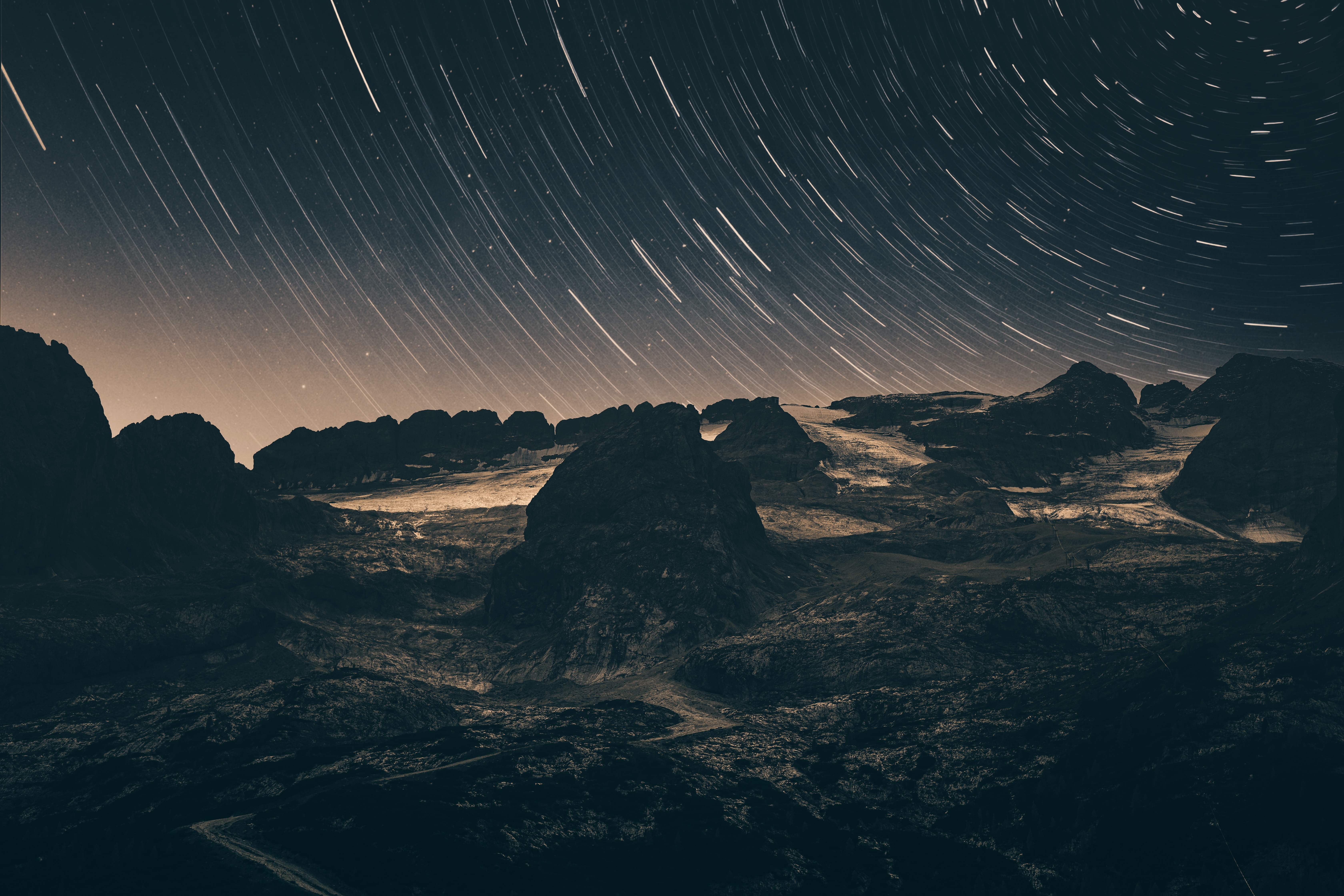 Star Trails Over Rocky Terrain at Night HD Wallpaper