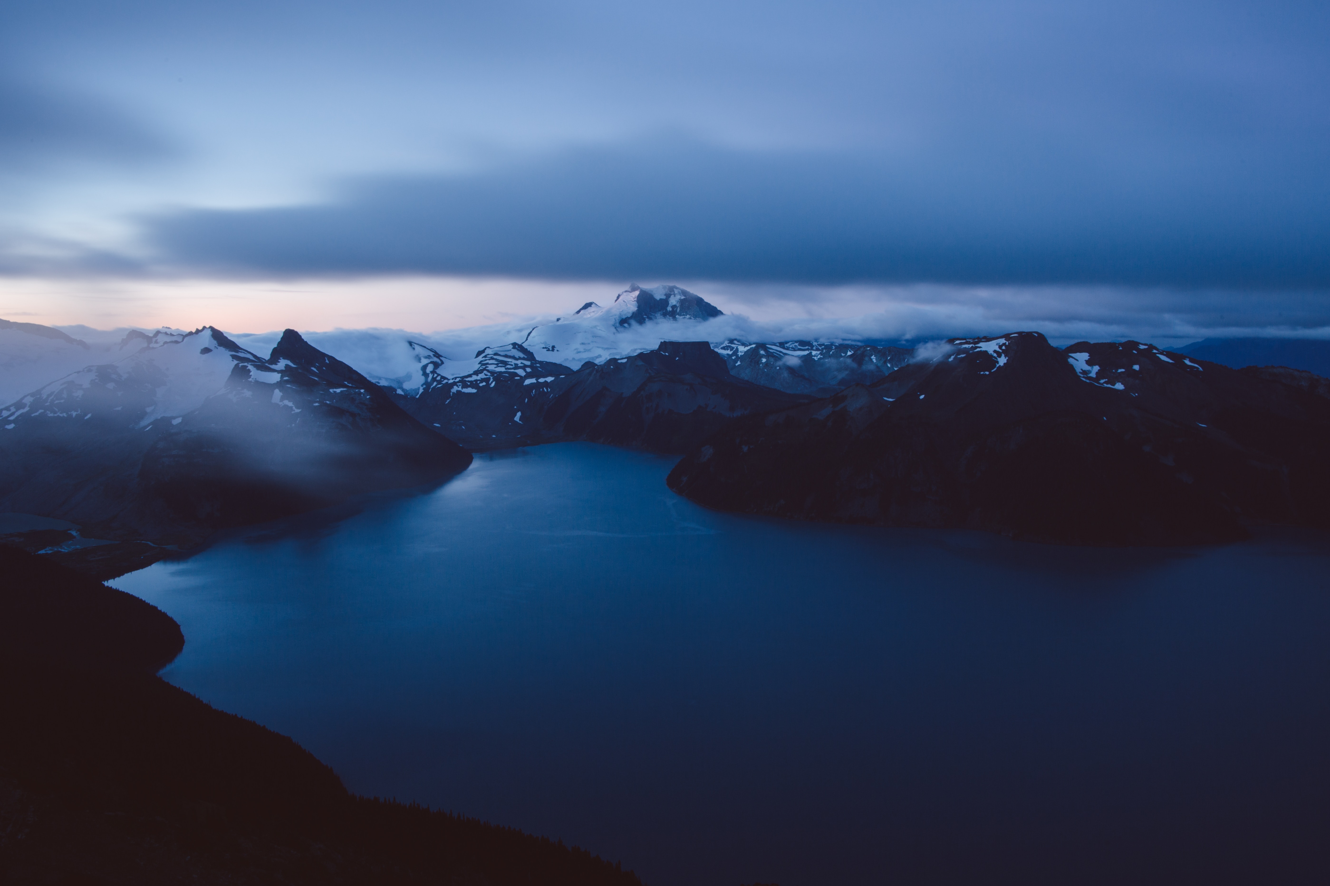 Dark Blue Lake Surrounded by Snow-Capped Mountains HD Wallpaper