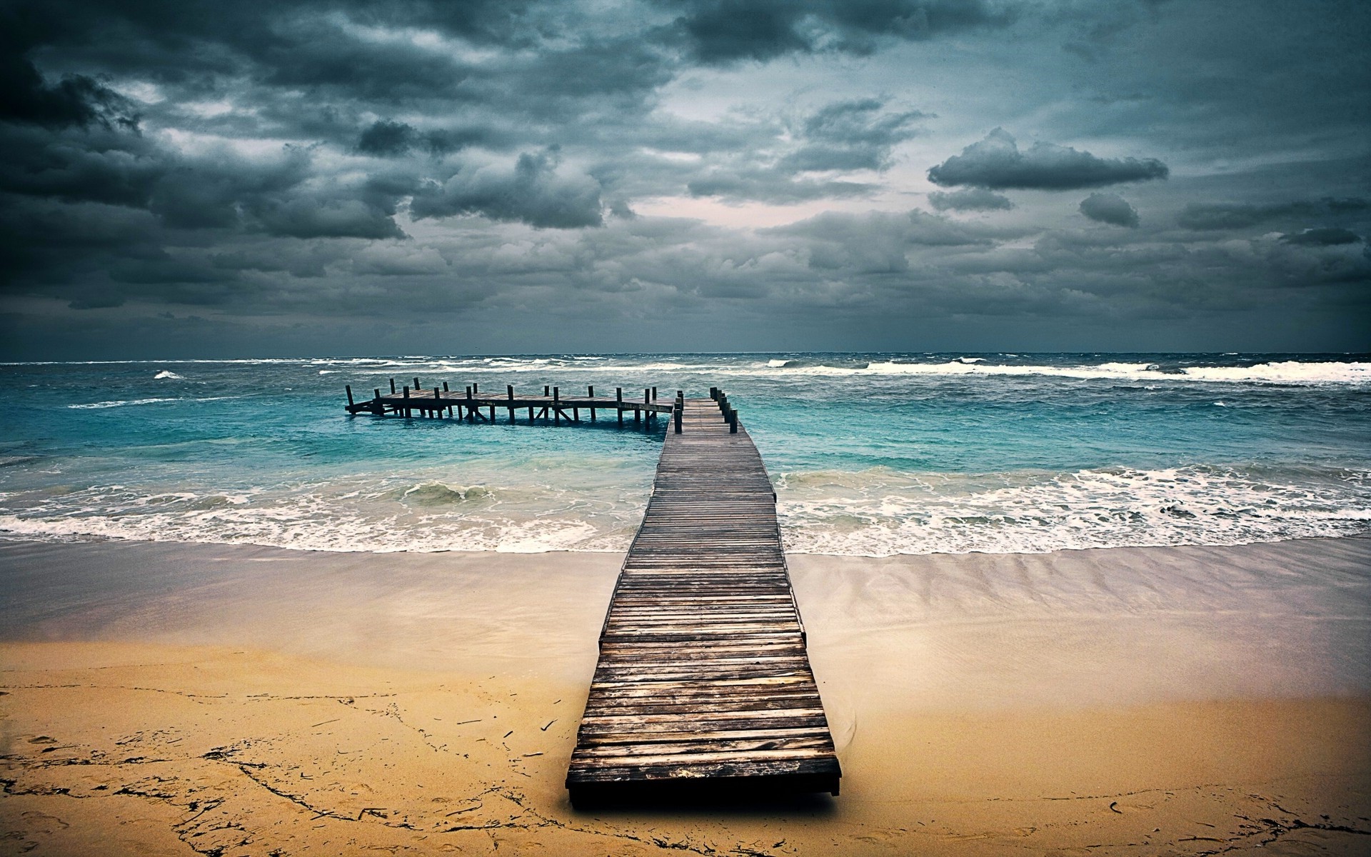Wooden pier on a beach with stormy clouds HD Wallpaper