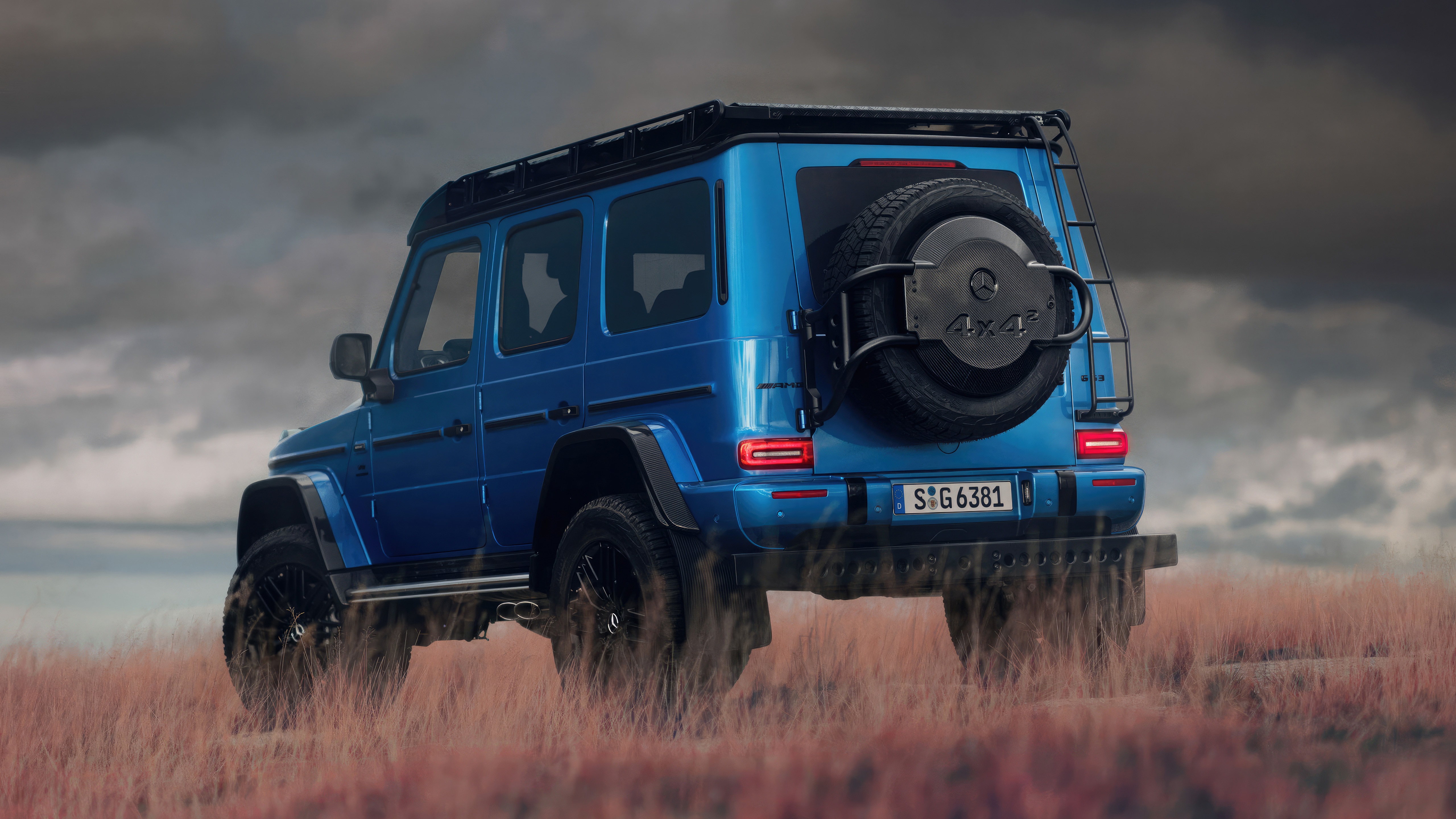 Blue Mercedes-AMG G63 4x4 SUV in a field HD Wallpaper