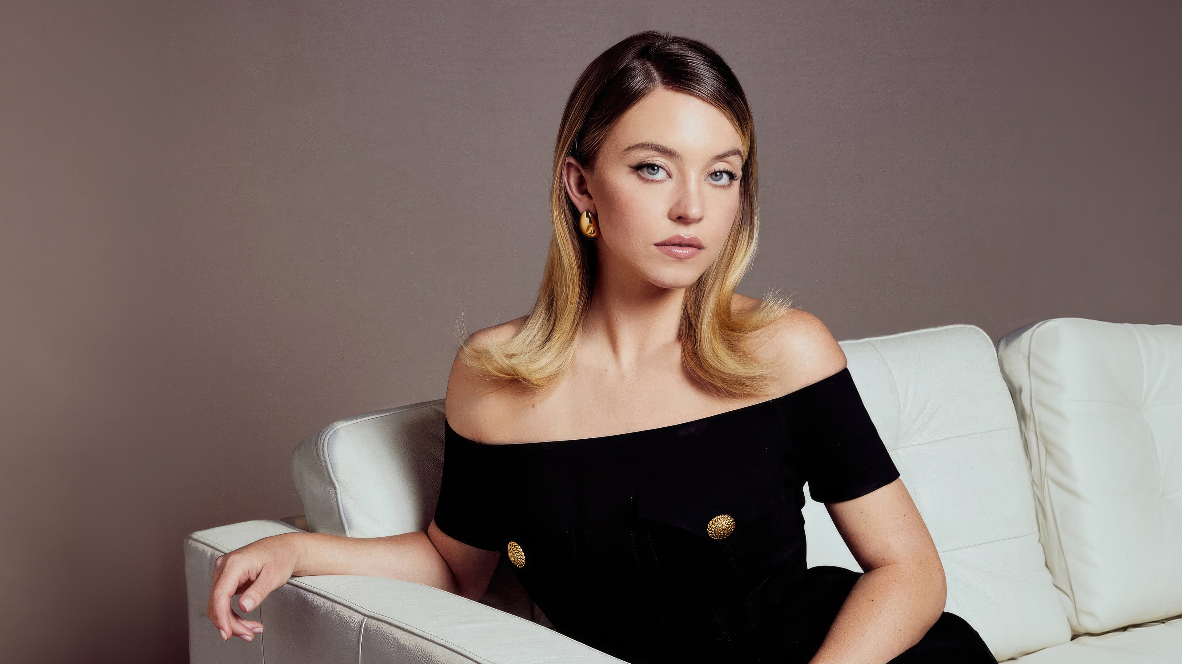 Sydney Sweeney on a white couch HD Wallpaper