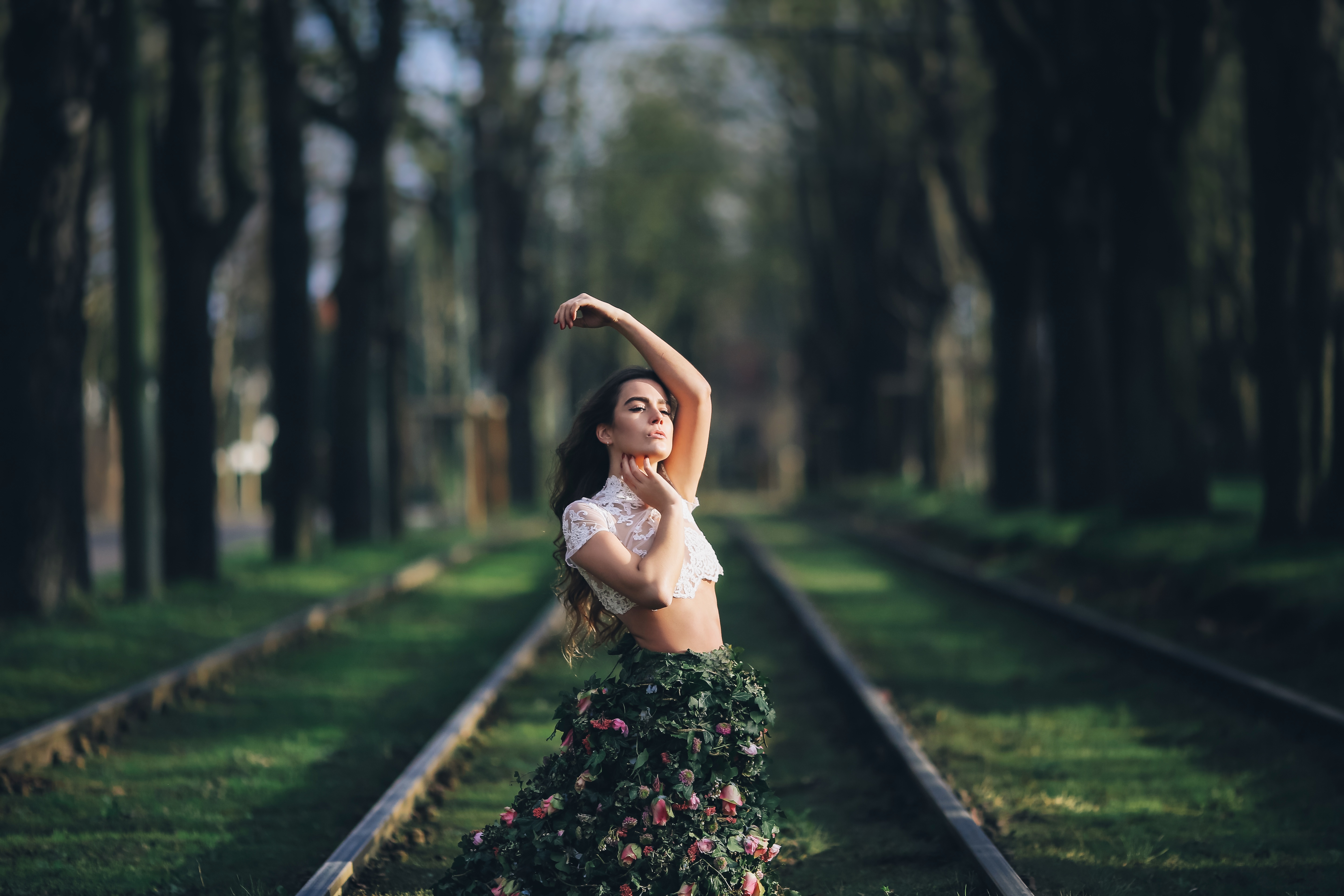 Woman in a floral dress on train tracks HD Wallpaper
