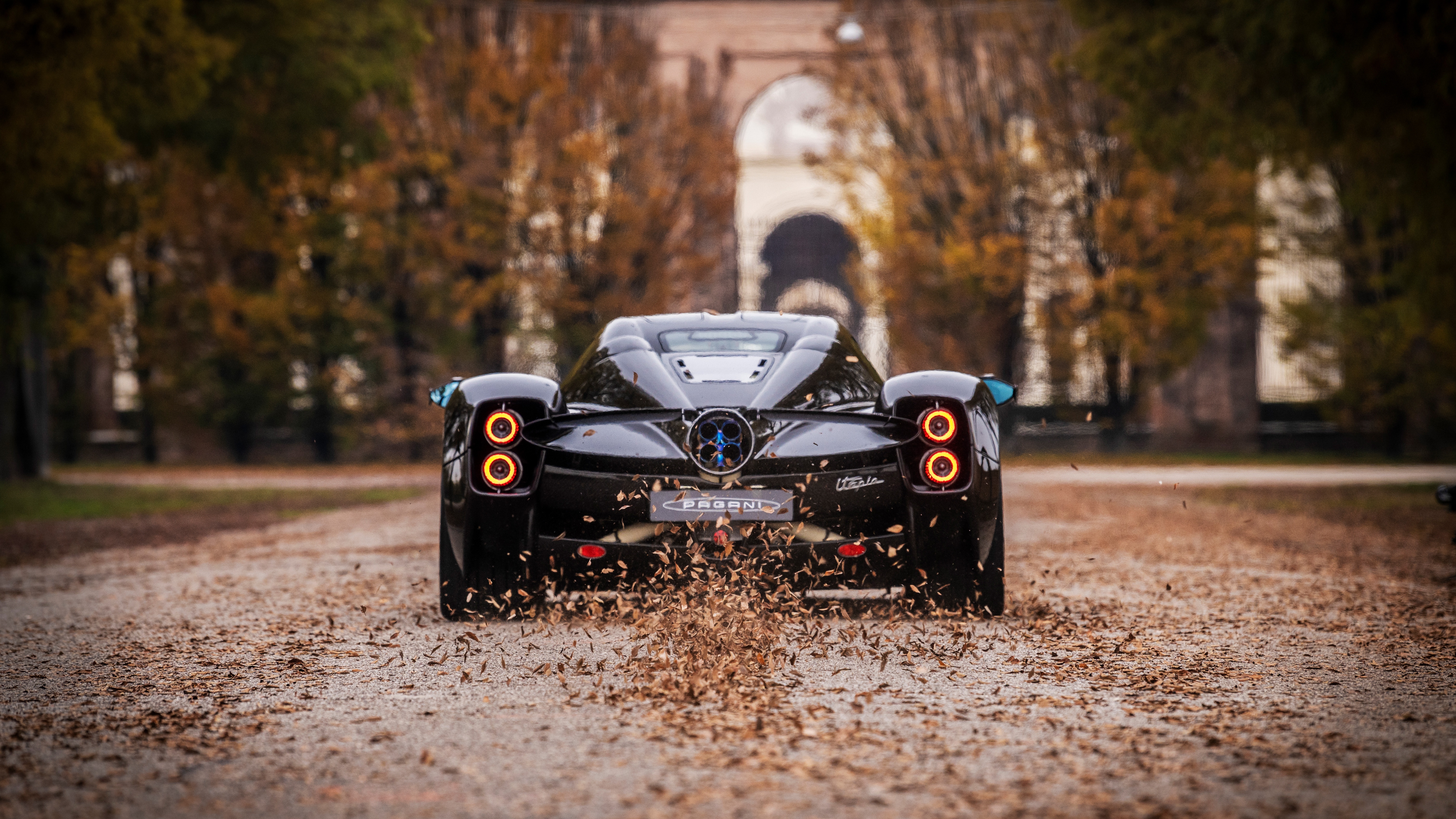 Pagani Utopia rear view on a leaf-covered road HD Wallpaper