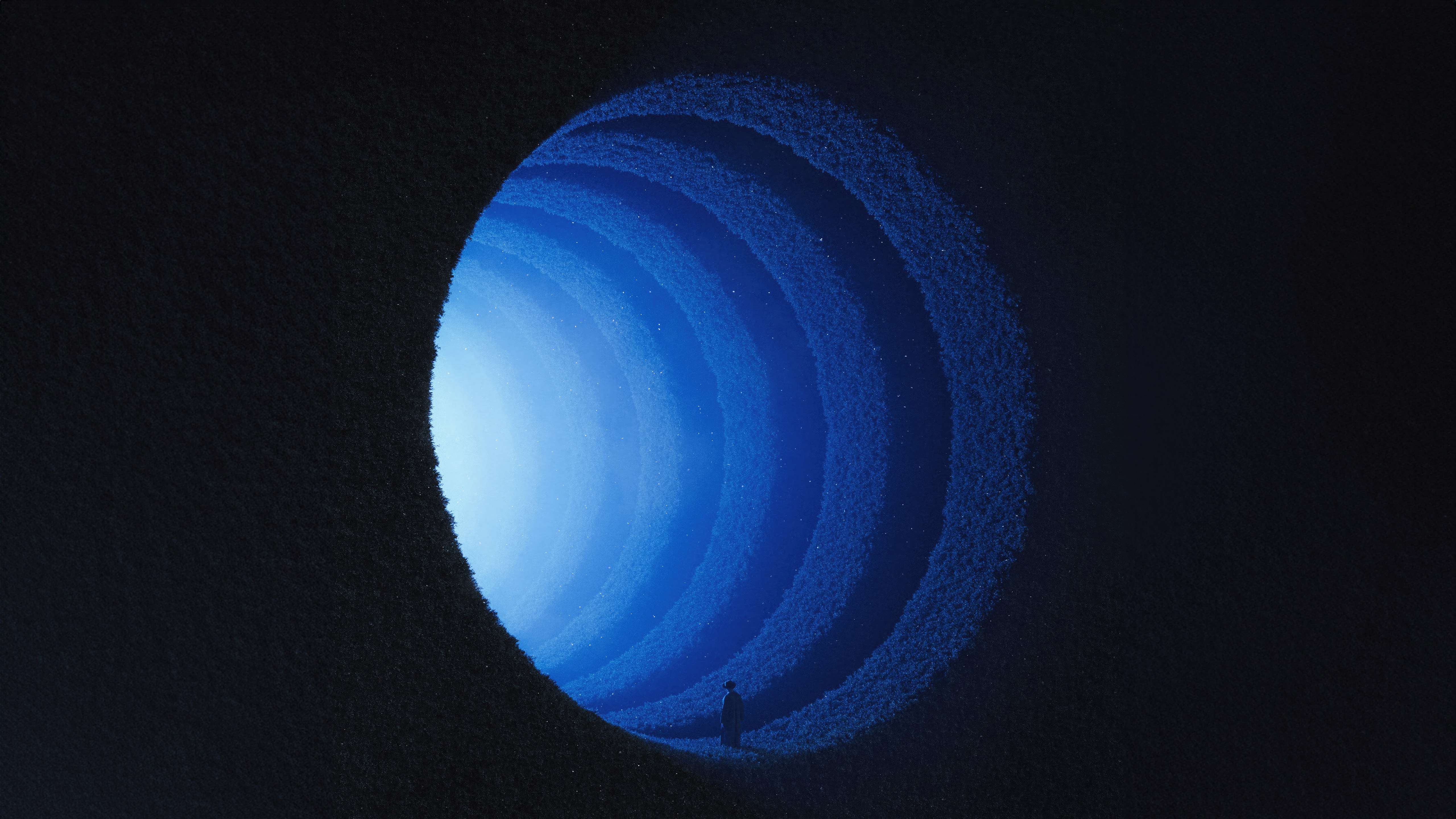 A person stands at the entrance of a blue glowing tunnel HD Wallpaper