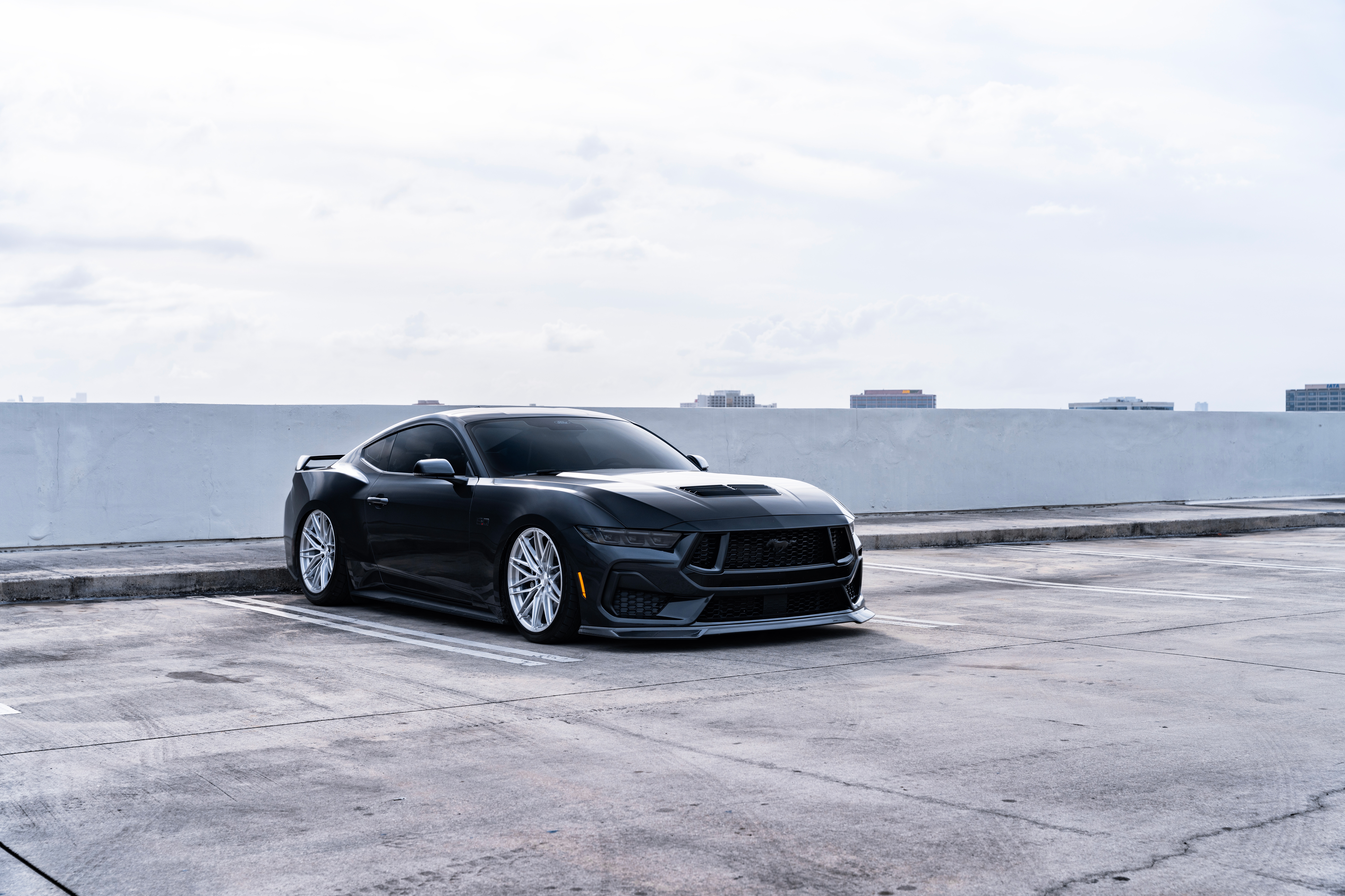 Black Ford Mustang parked in a lot HD Wallpaper